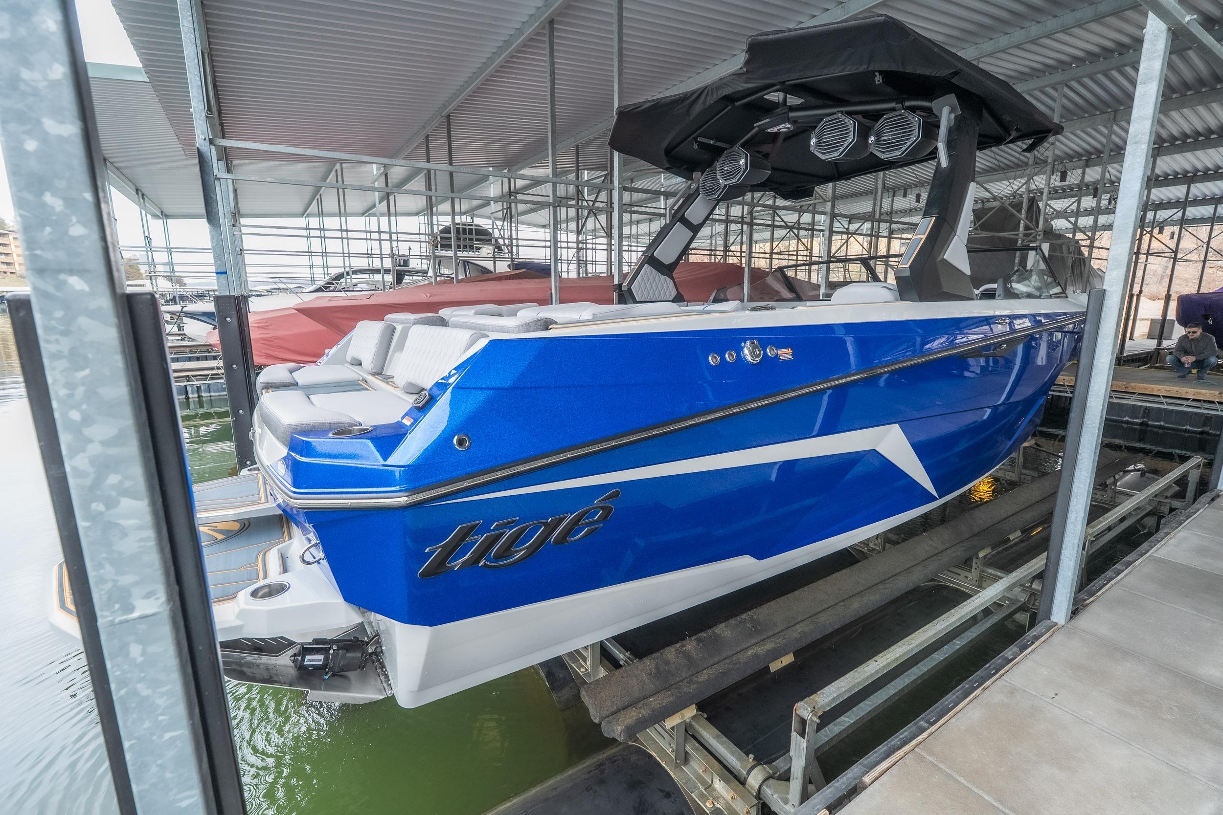 2026 Tigé Z3 boat in blue, docked in a covered marina.