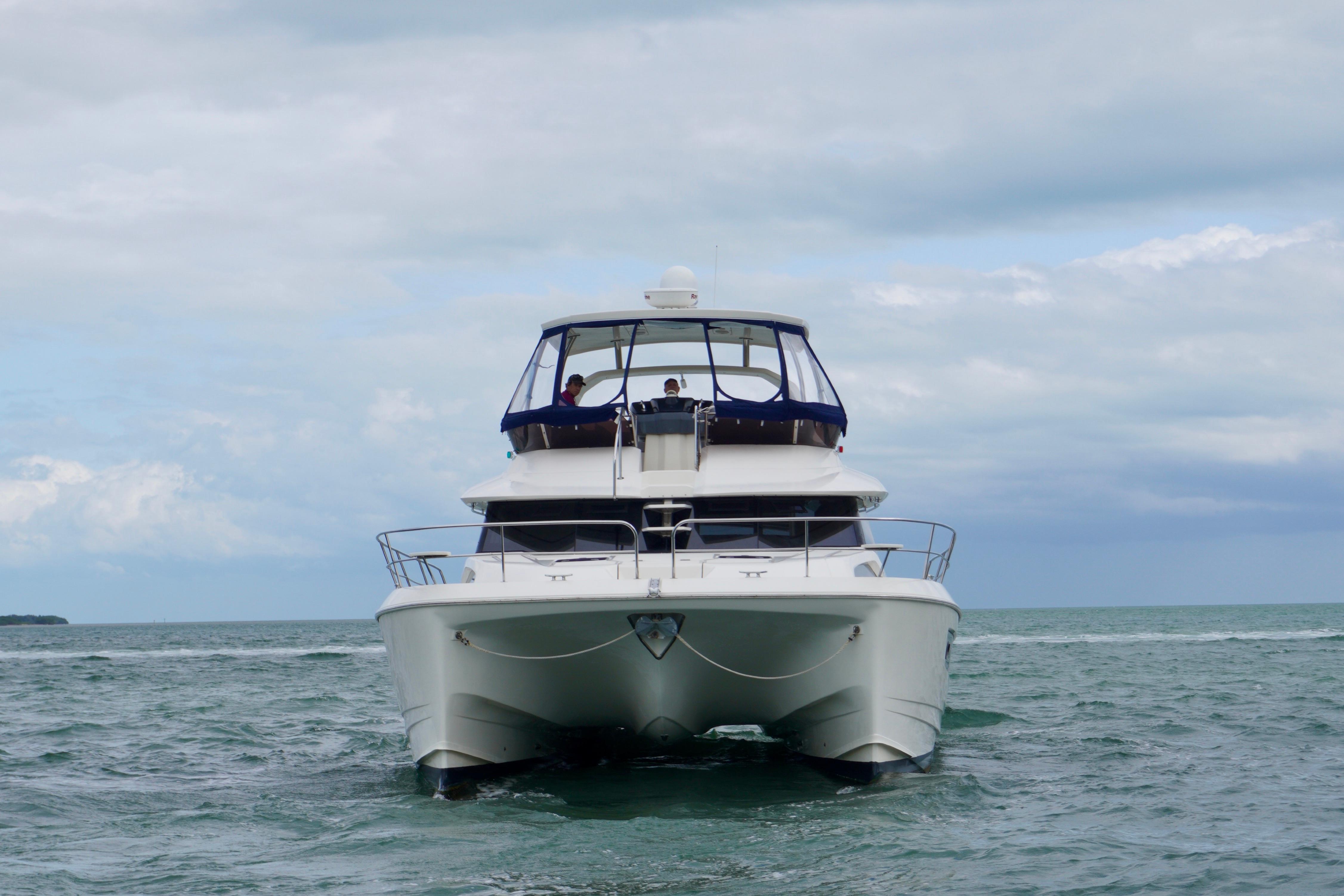 Front view of a 2017 Aquila 44 Yacht cruising on the ocean.