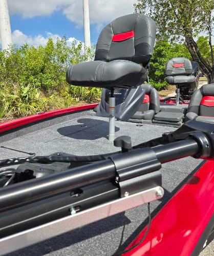 2025 Tracker Pro Team 175 boat with red and black seating, outdoor setting.
