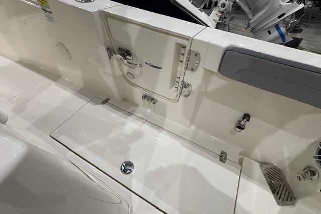 2026 Cobia 245 Center Console boat interior with storage compartments and seating.