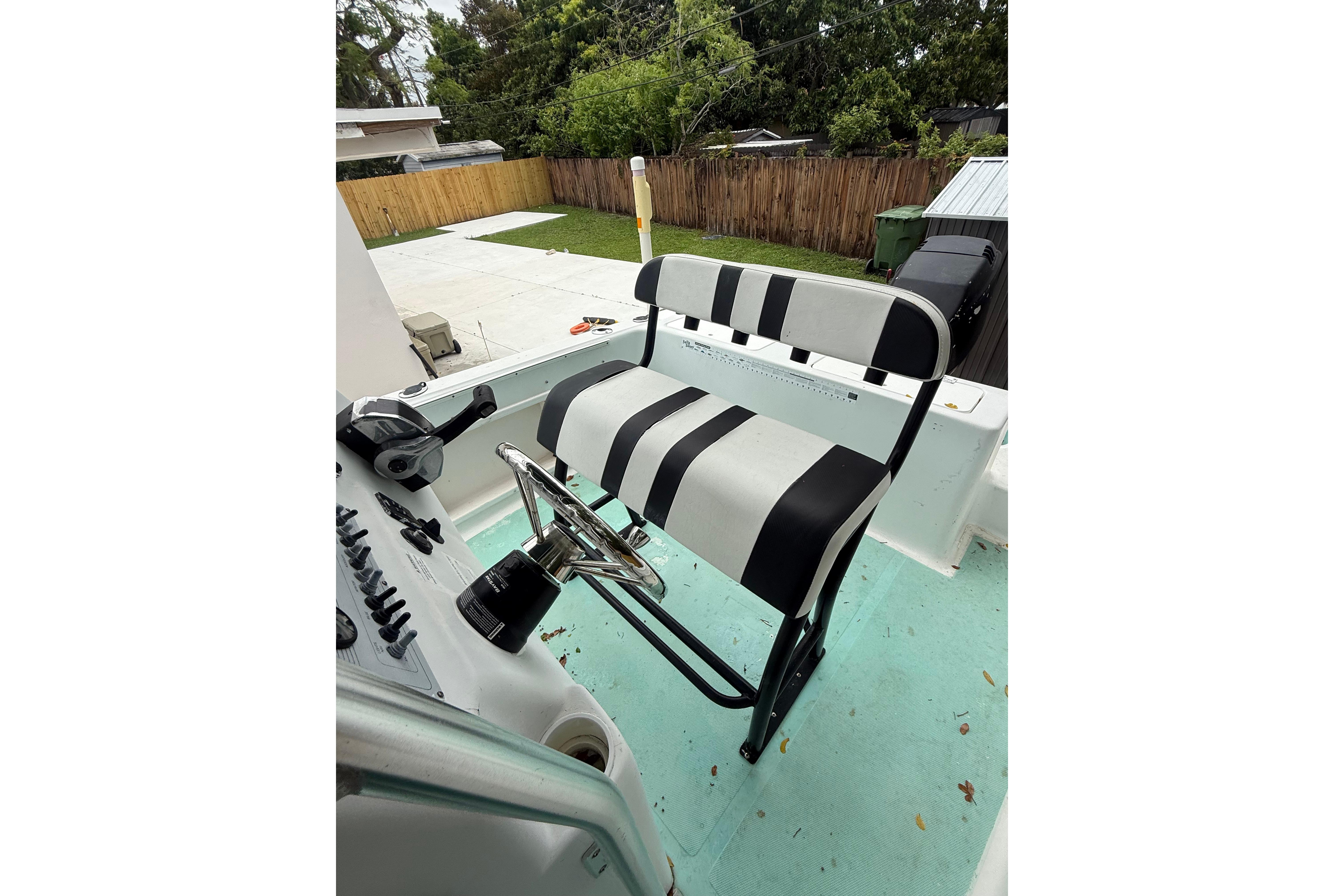 2005 LYG Sea Fox boat helm with striped seat and steering wheel.
