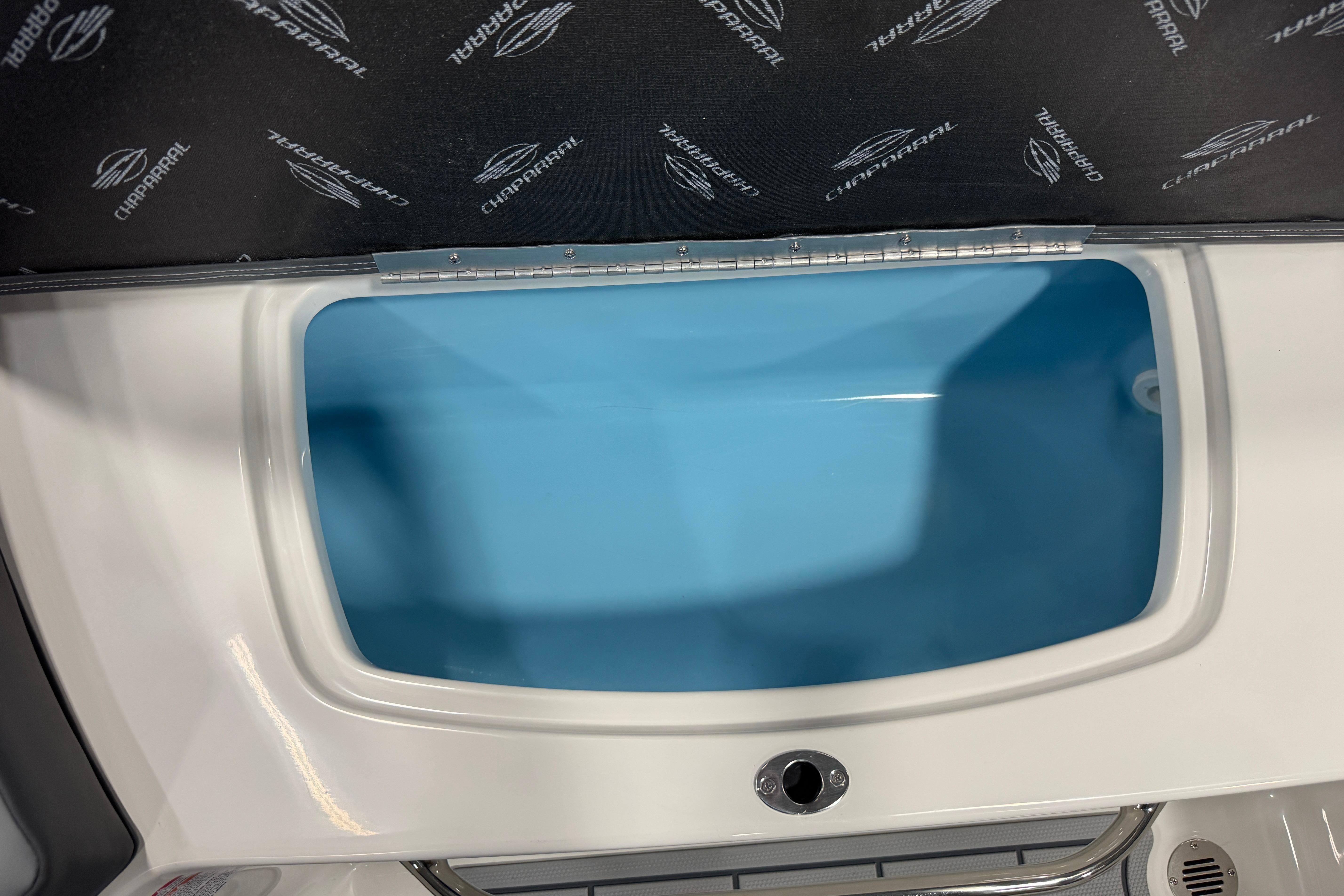 2026 Chaparral 23 SSi boat storage compartment with blue interior and Chaparral branding.