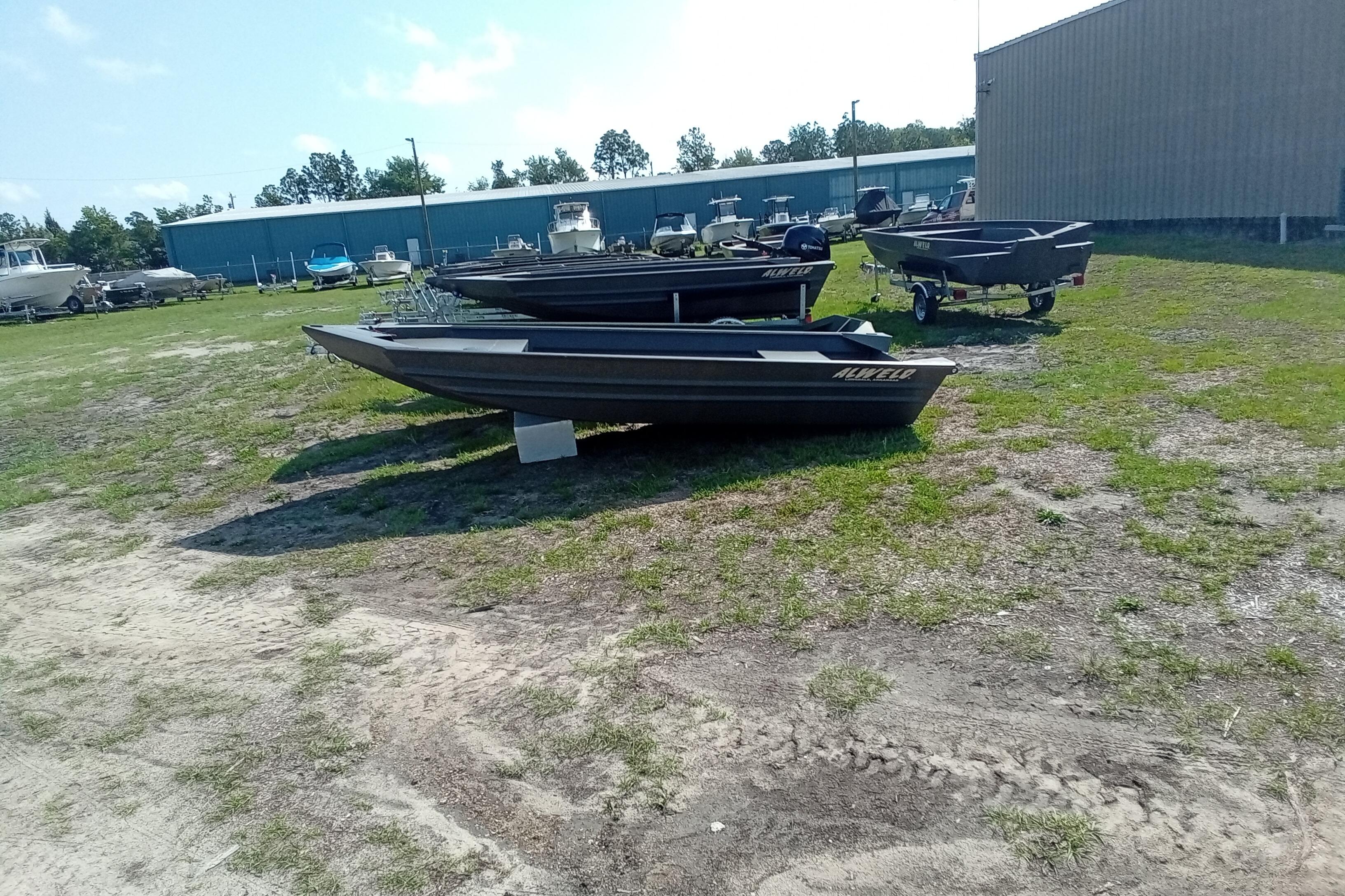 2026 Alweld 1548VV Marsh boats displayed outdoors on grassy lot.