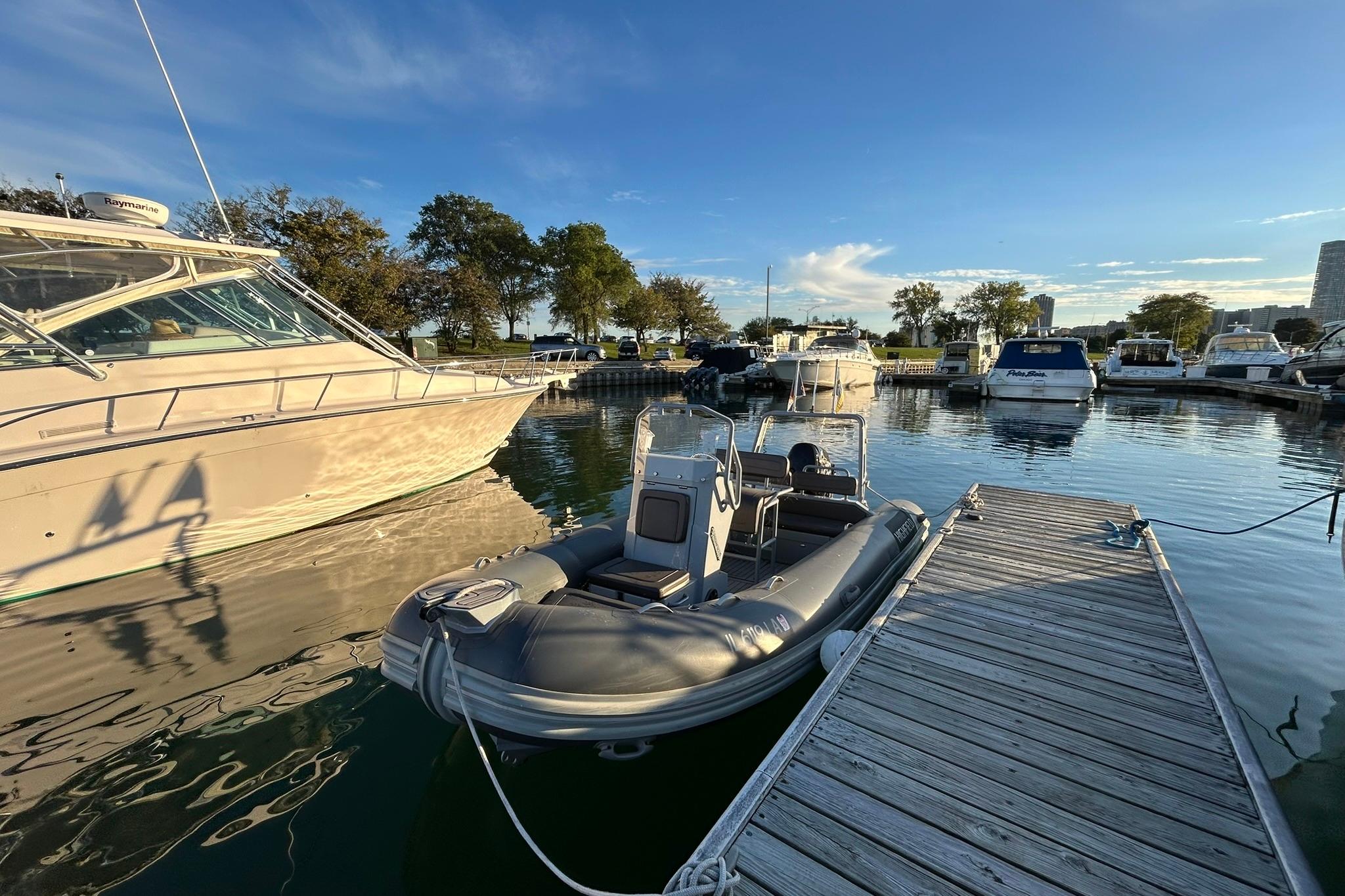 2007 Grady-White Express 360 docked at marina with inflatable boat nearby.