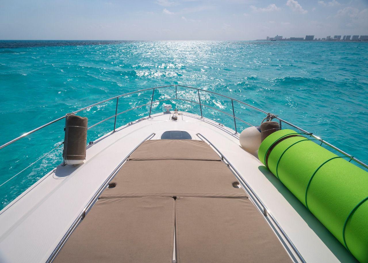 2006 Sea Ray 440 Sundancer cruising on turquoise ocean waters.