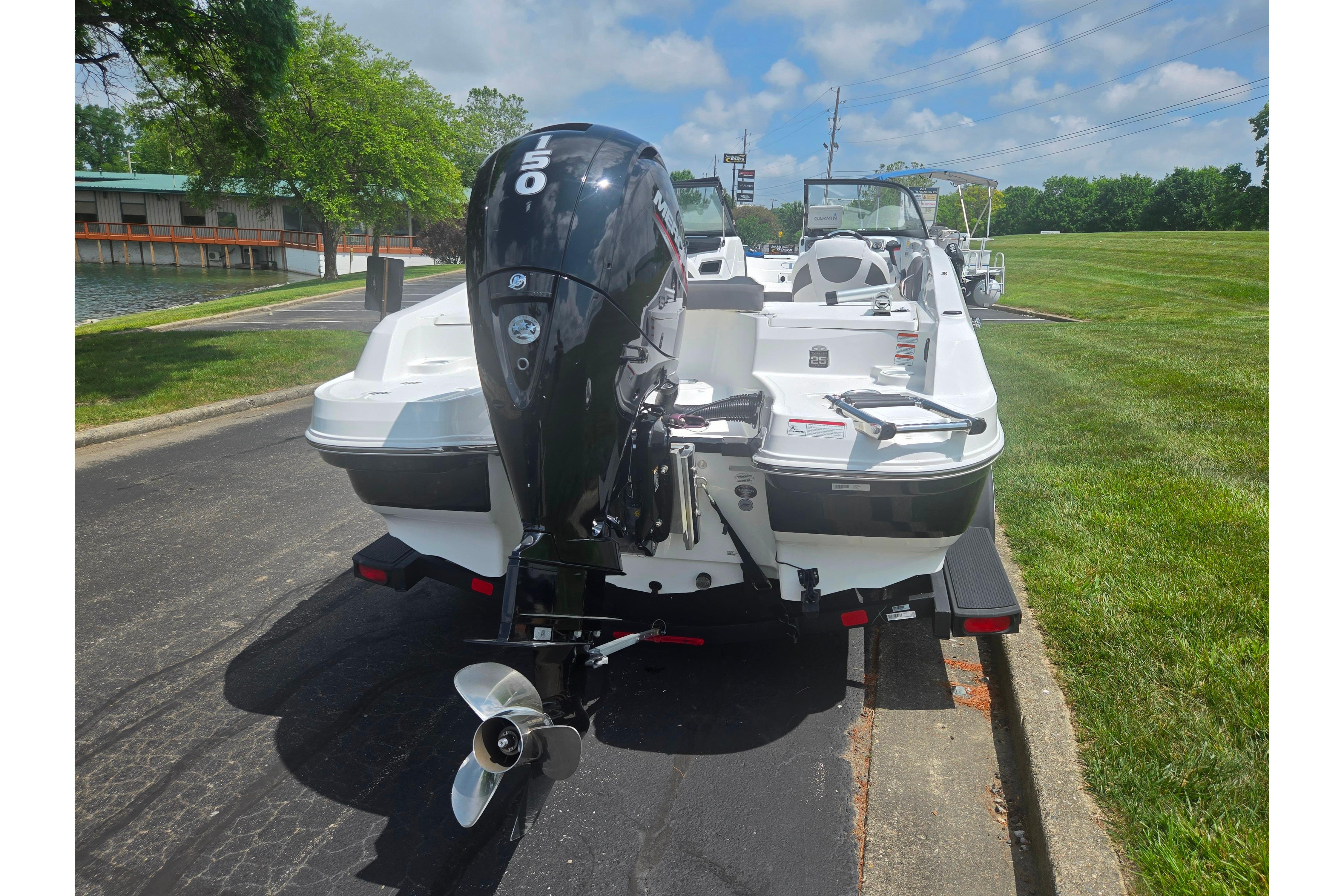 2023 Tahoe 200 S boat with powerful outboard motor, parked on a sunny day.