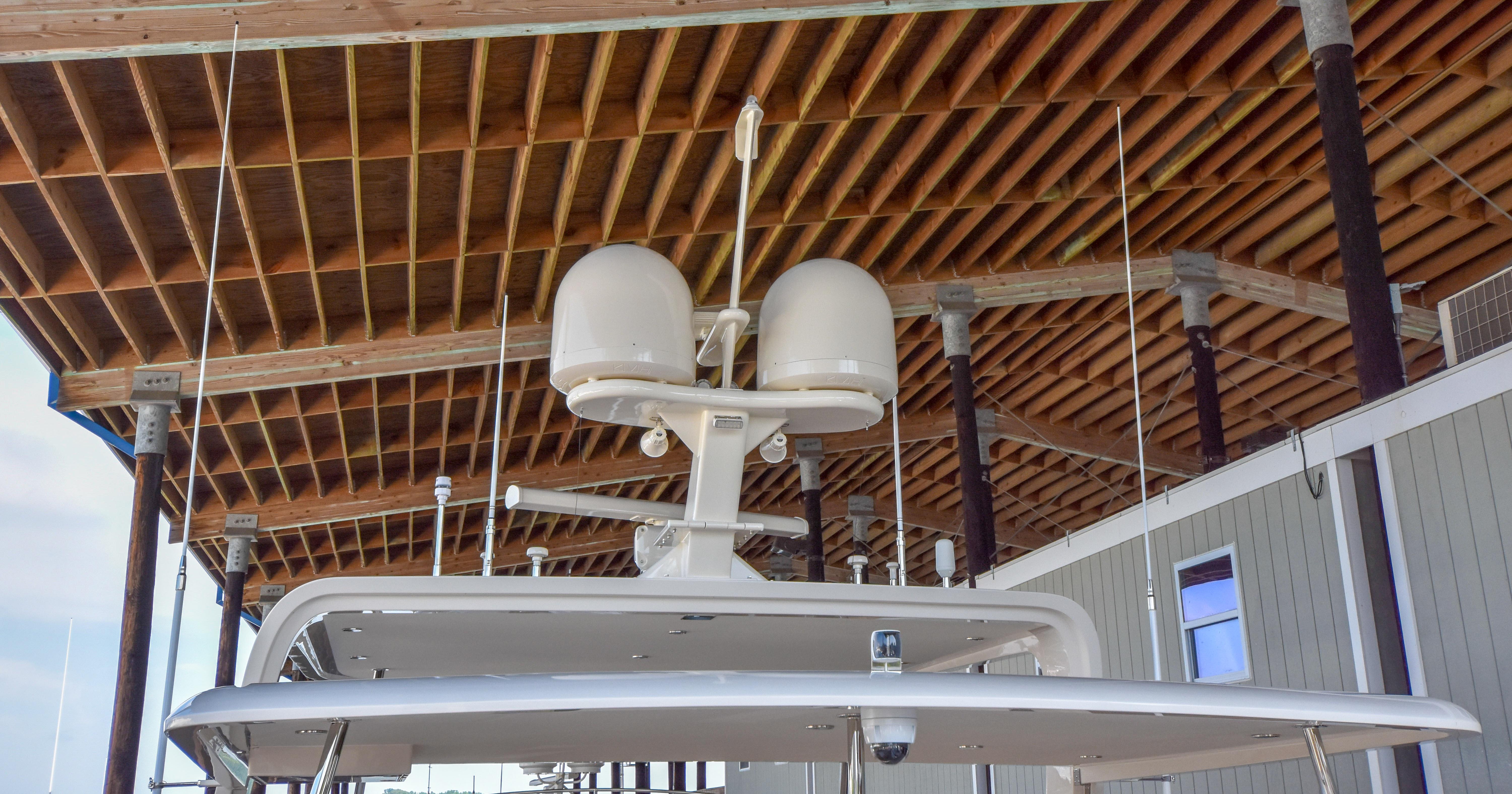 2020 Fleming 78 yacht radar equipment under wooden dock roof.