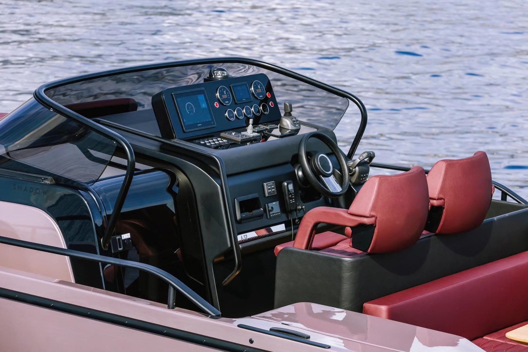 Cockpit of 2026 Cranchi A32 Luxury Tender with red seats and modern controls.