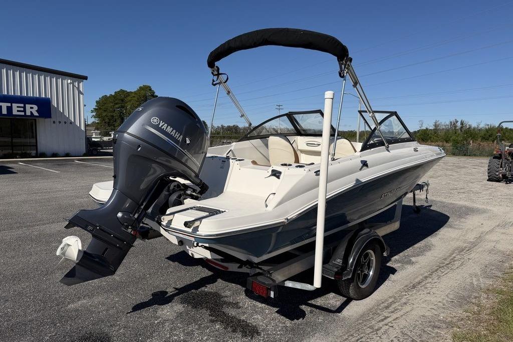 2024 Stingray 191 DC boat with Yamaha outboard motor, parked outdoors.