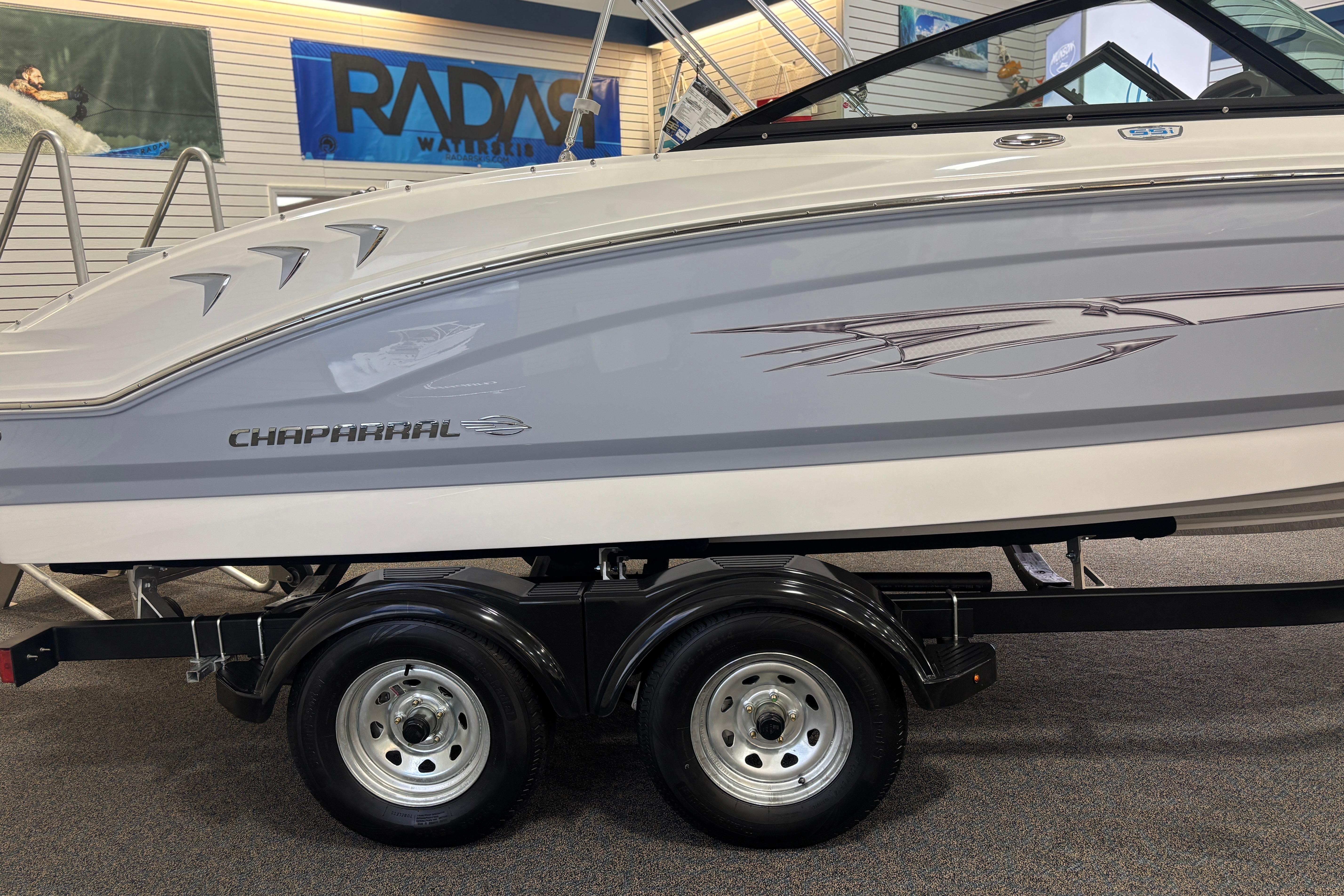 Chaparral 21 SSi Ski & Fish 2026 on trailer in showroom.