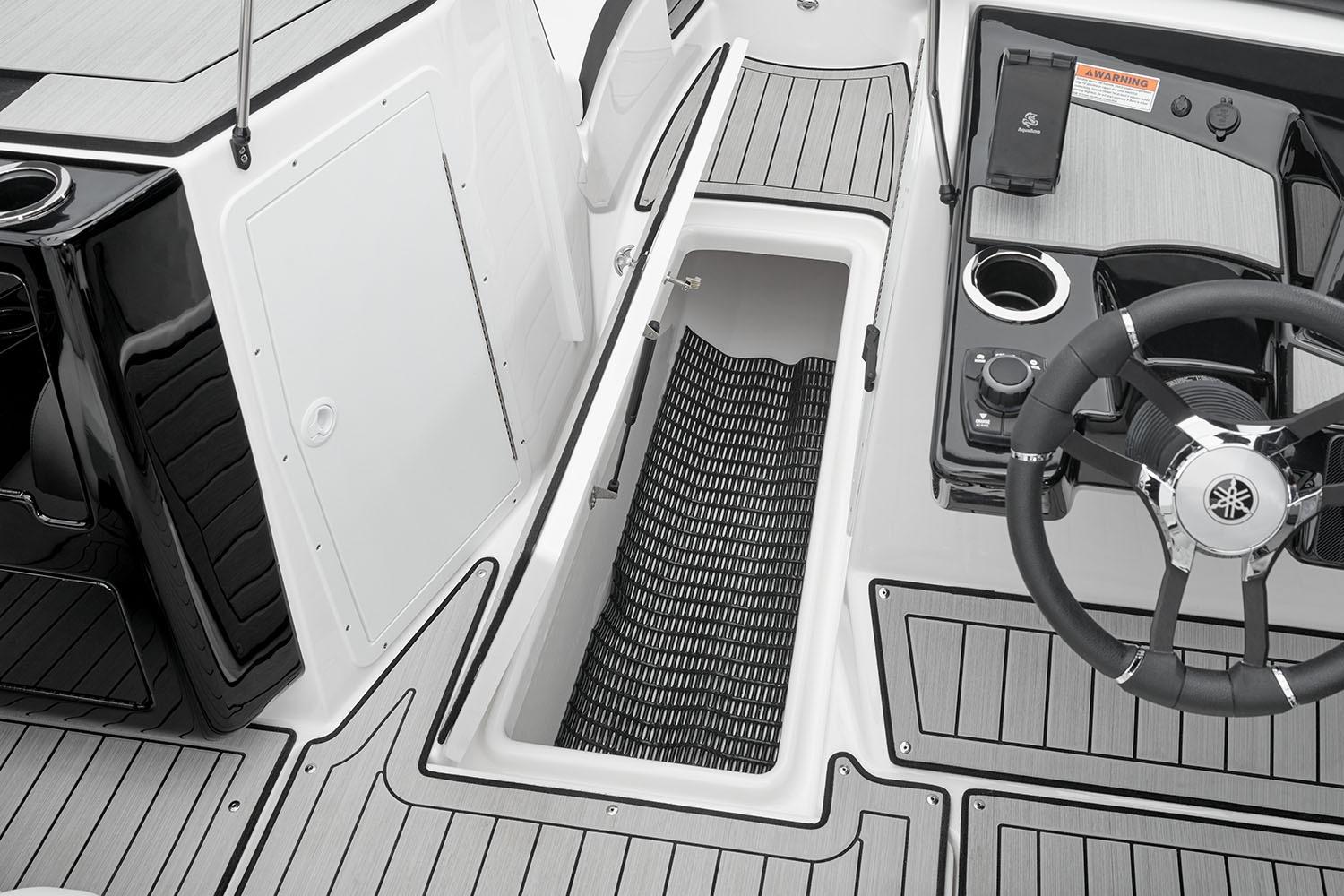 Manufacturer Provided Image: 2026 Yamaha Boats 222S interior with open storage compartment and steering wheel.