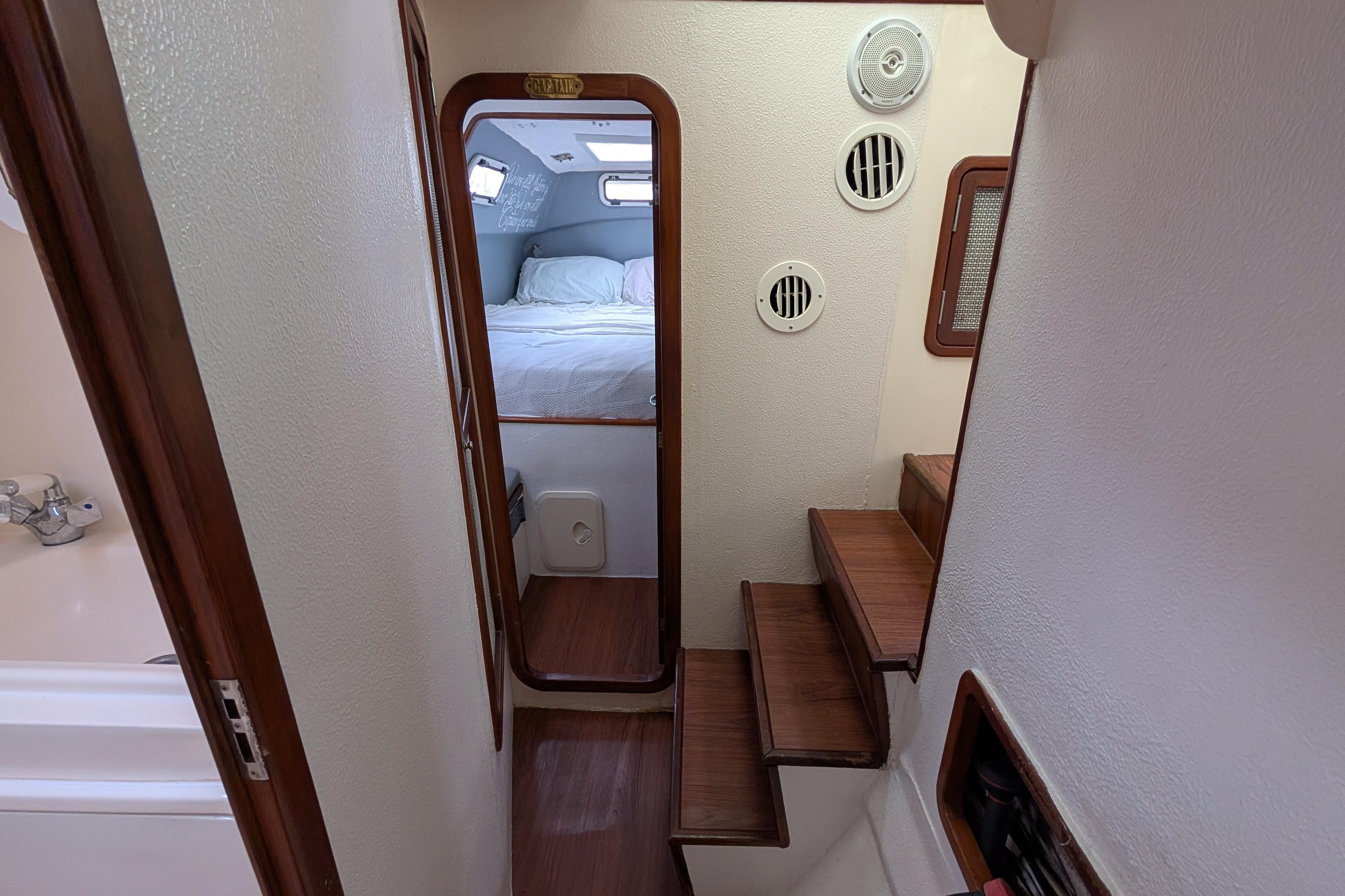 Interior of 1999 Island Spirit 37 yacht showing stairs and cozy cabin.
