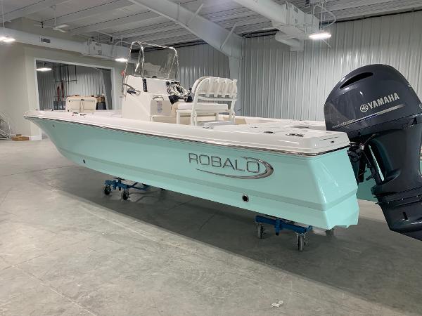2026 Robalo 226 Cayman boat with Yamaha engine in a showroom.