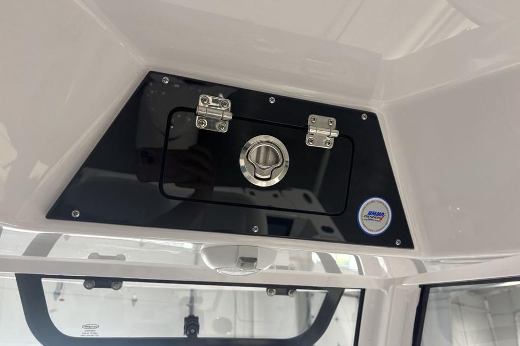 2026 Sportsman Open 252 Center Console storage compartment with secure latch and NMMA certification.