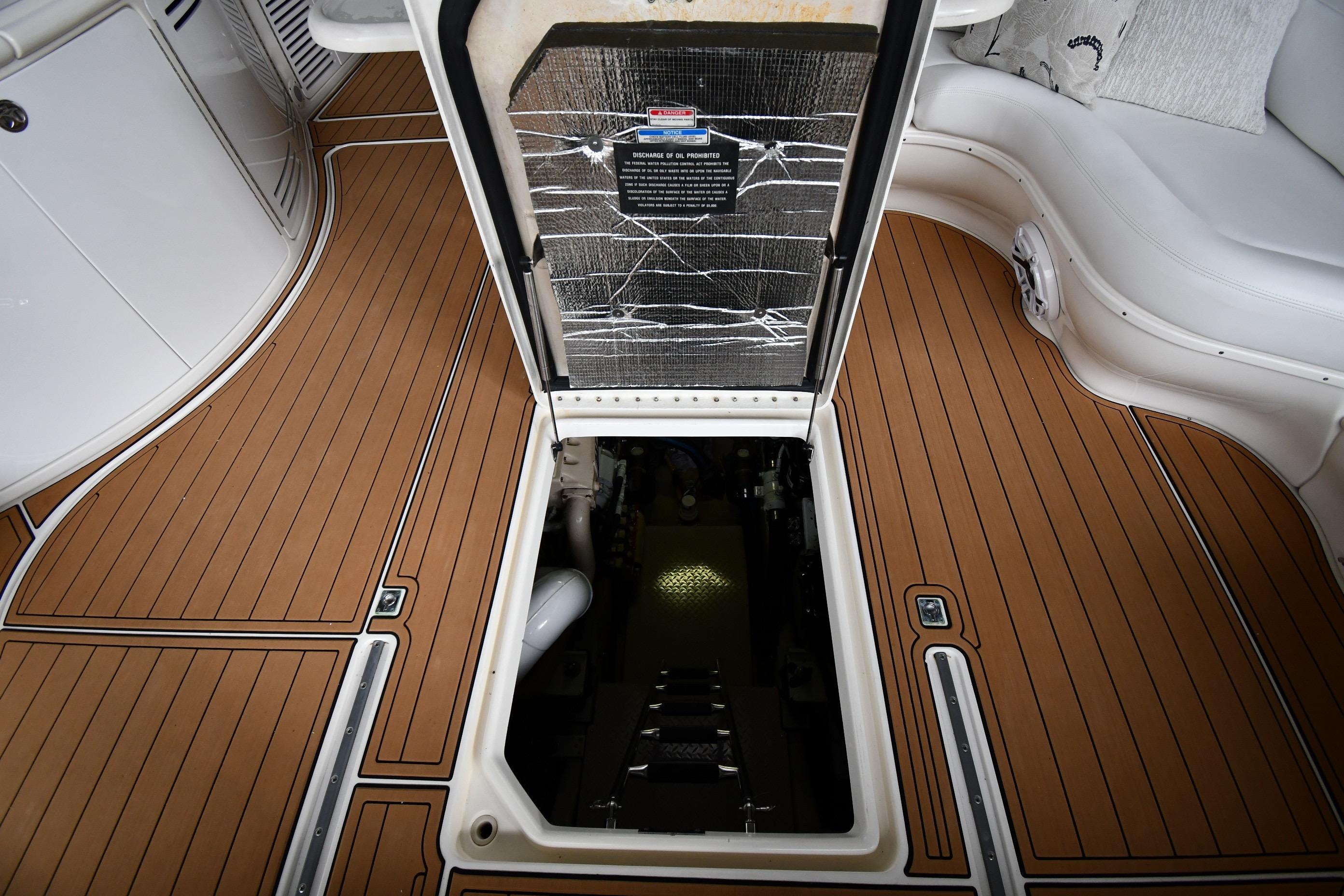Engine compartment access on 2001 Sea Ray 540 Sundancer yacht with teak flooring.