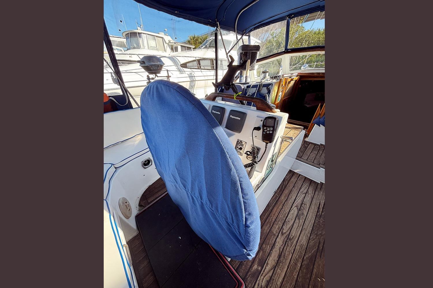 Cockpit of 1993 Gozzard 44 MK1 AC sailboat with covered steering wheel.
