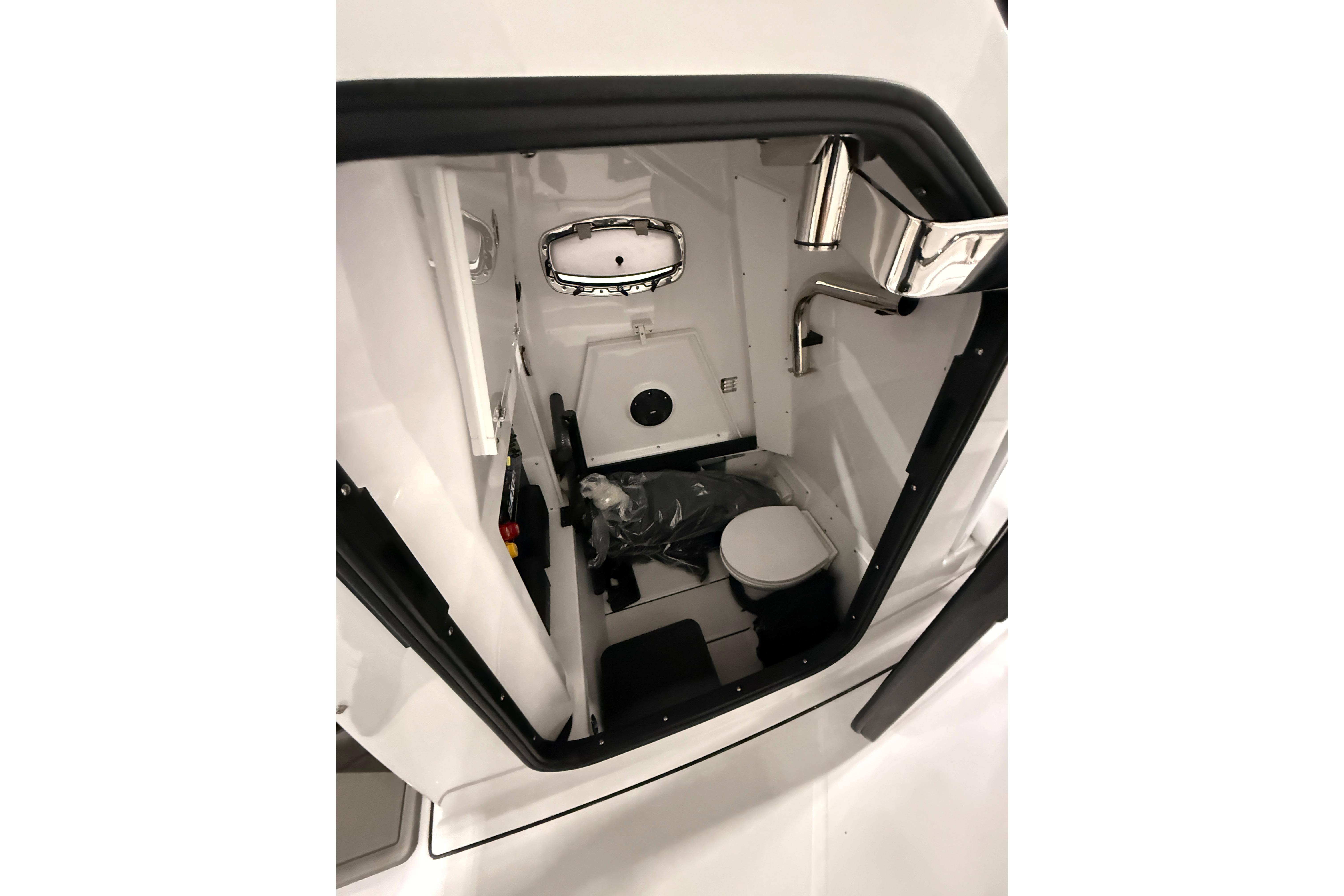 Interior view of 2026 Blackfin 302 CC boat's compact bathroom.