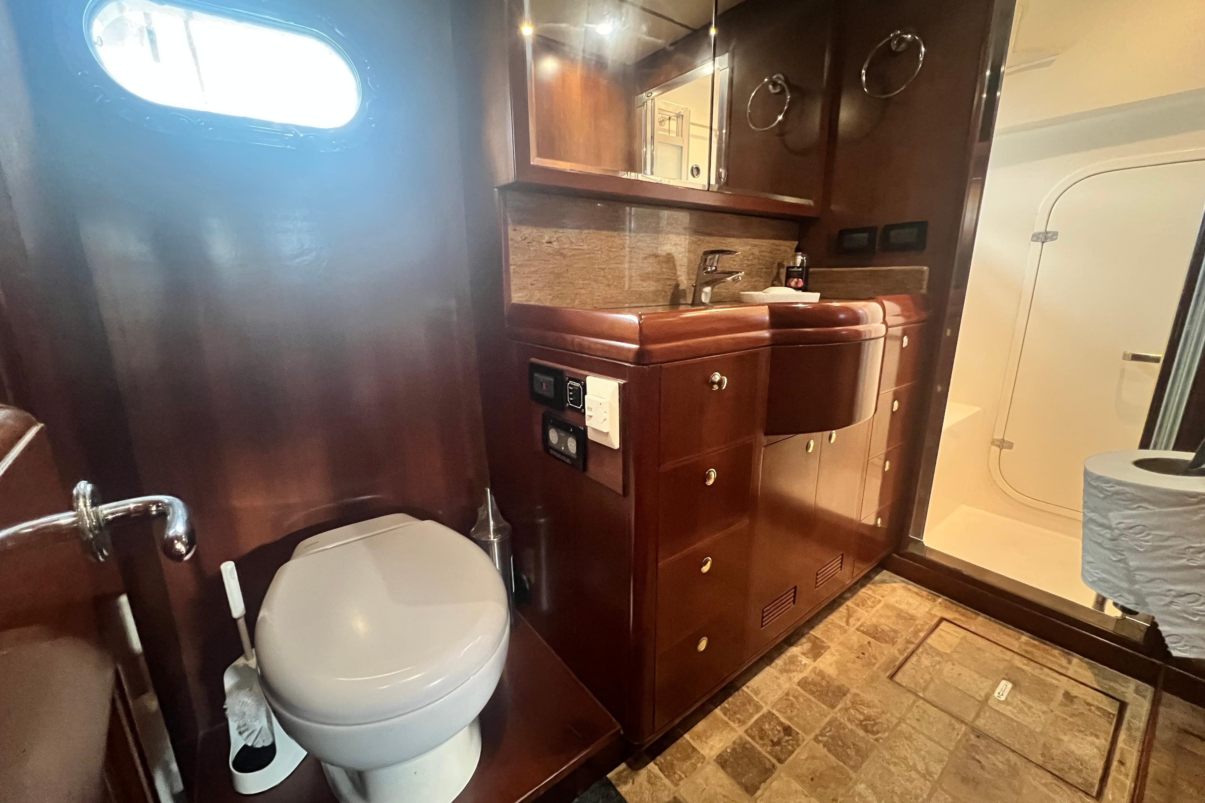 Luxurious bathroom in 2009 Nordhavn 56 Motorsailer with wood cabinetry and modern fixtures.
