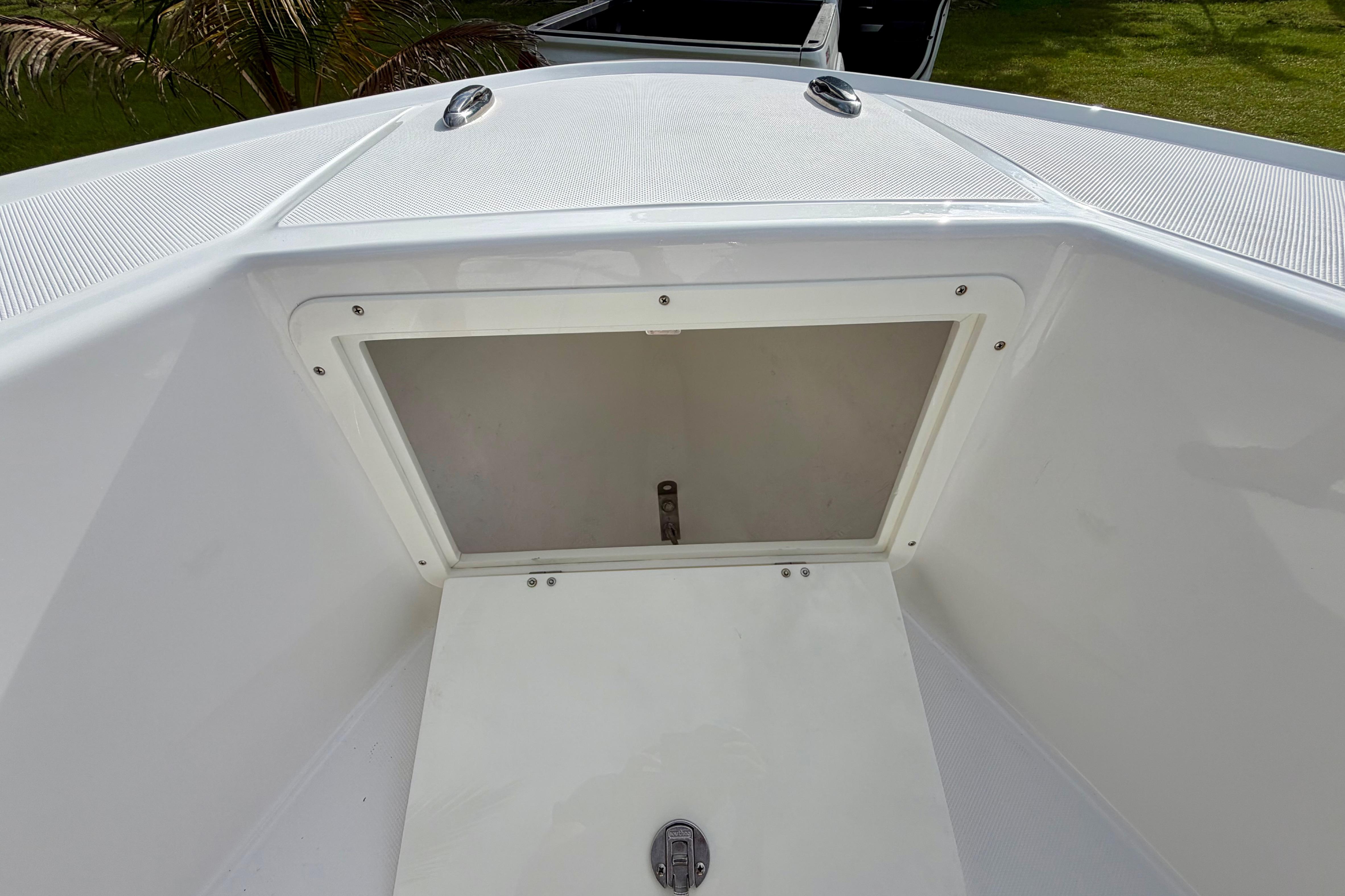 2025 Ocean Master 296 Center Console boat storage compartment, open and empty.
