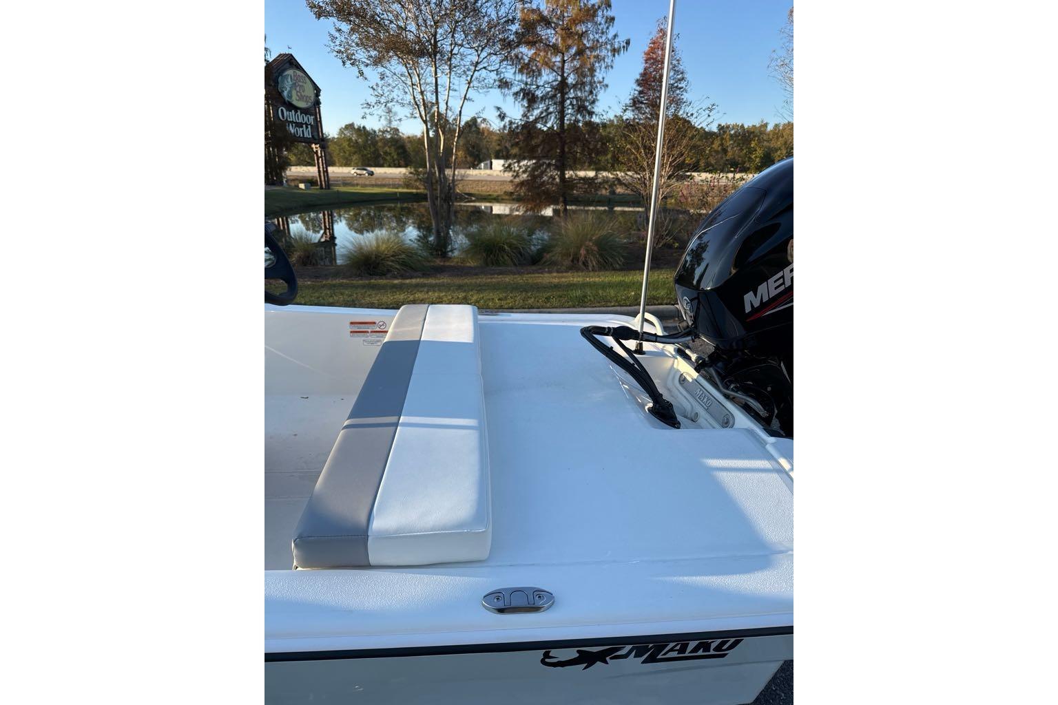2026 Mako Pro Skiff 13 CC boat with Mercury engine, outdoor setting.