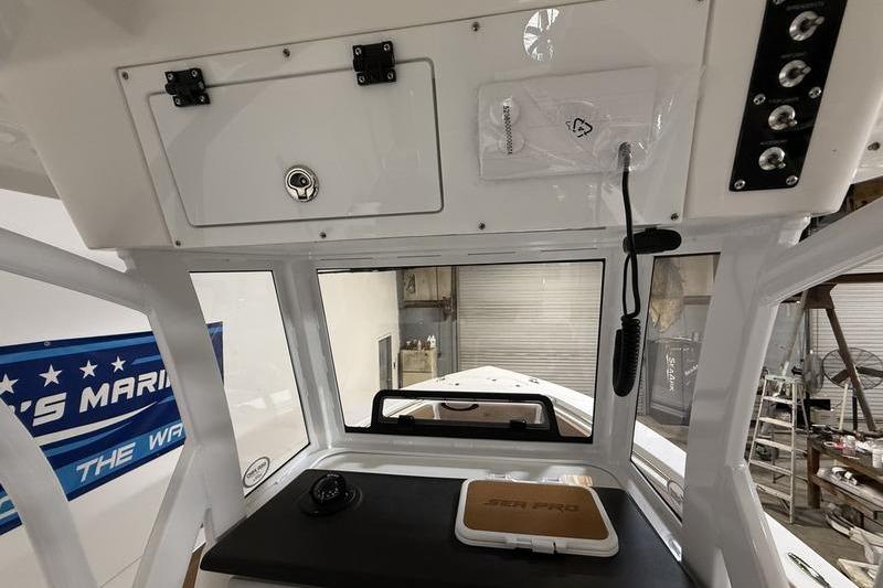 2026 Sea Pro 242 Center Console interior with control panel and storage compartments.