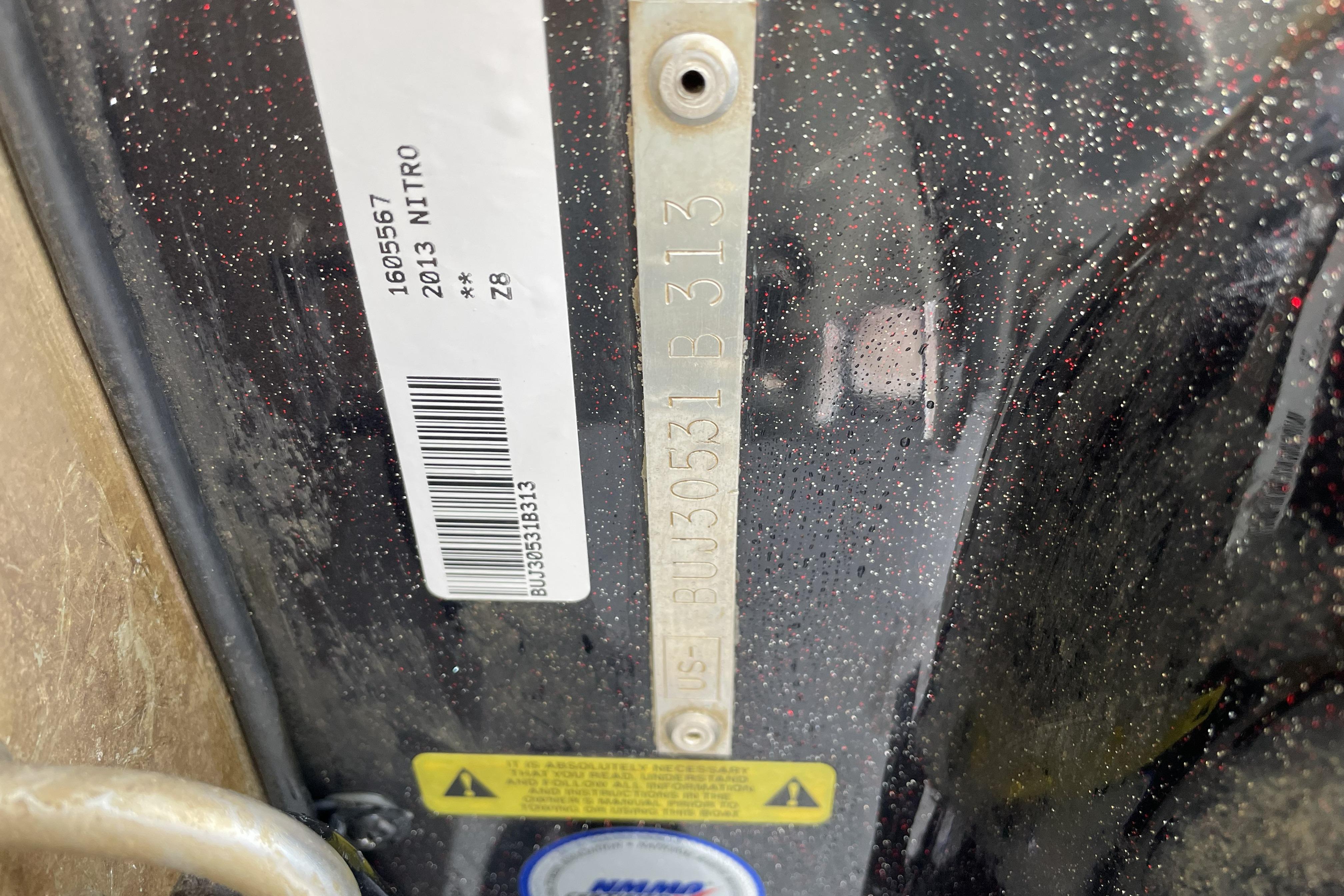 Close-up of a 2013 Nitro Z-8 model identification plate with barcode.