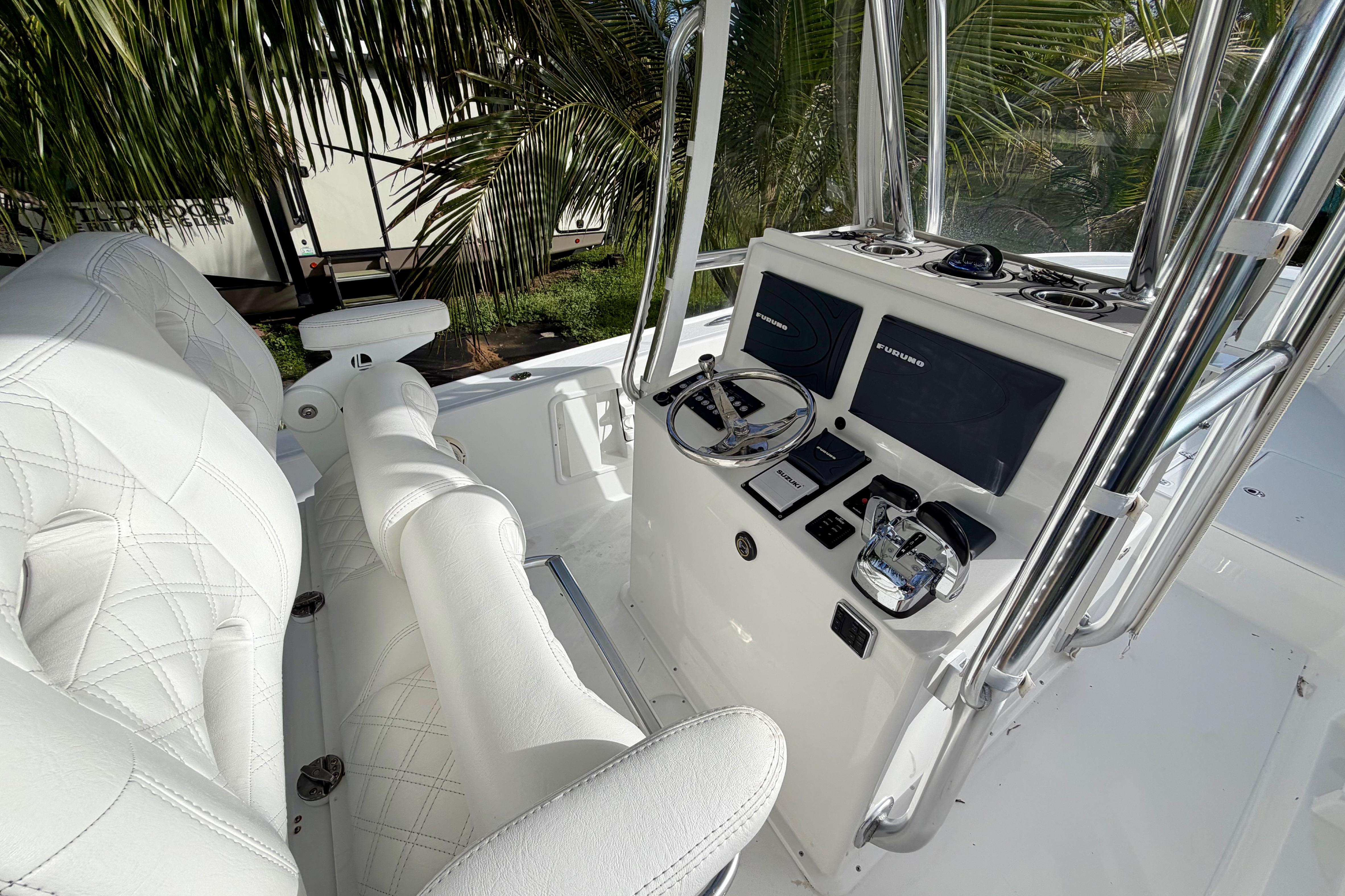 2025 Ocean Master 296 Center Console boat interior with modern controls and white seating.