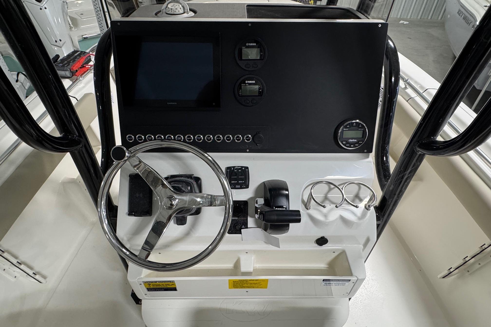 2026 Key West 239 FS boat console with steering wheel and electronic controls.
