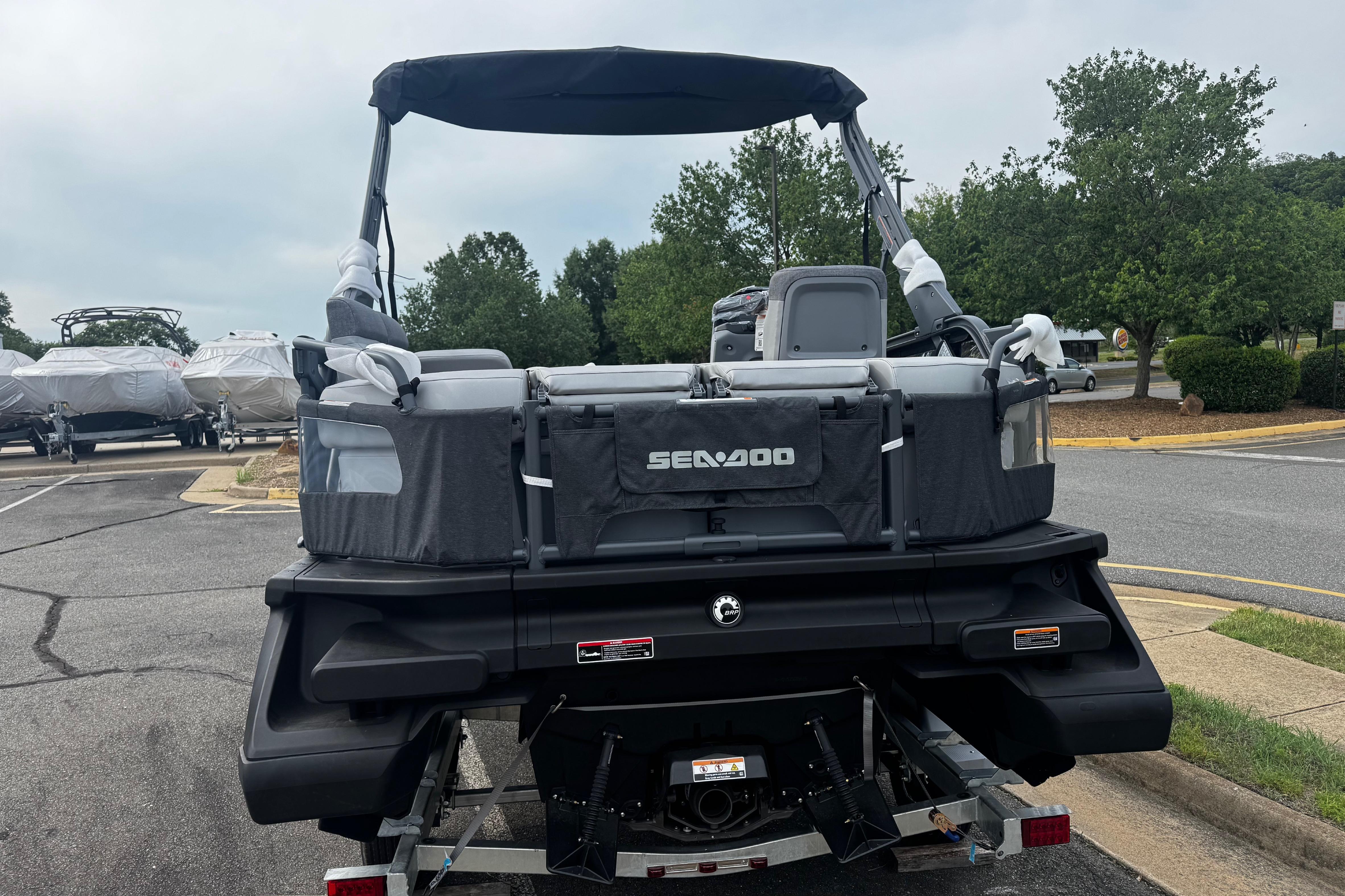 2026 Sea-Doo Switch Compact pontoon boat parked on a trailer in a lot.