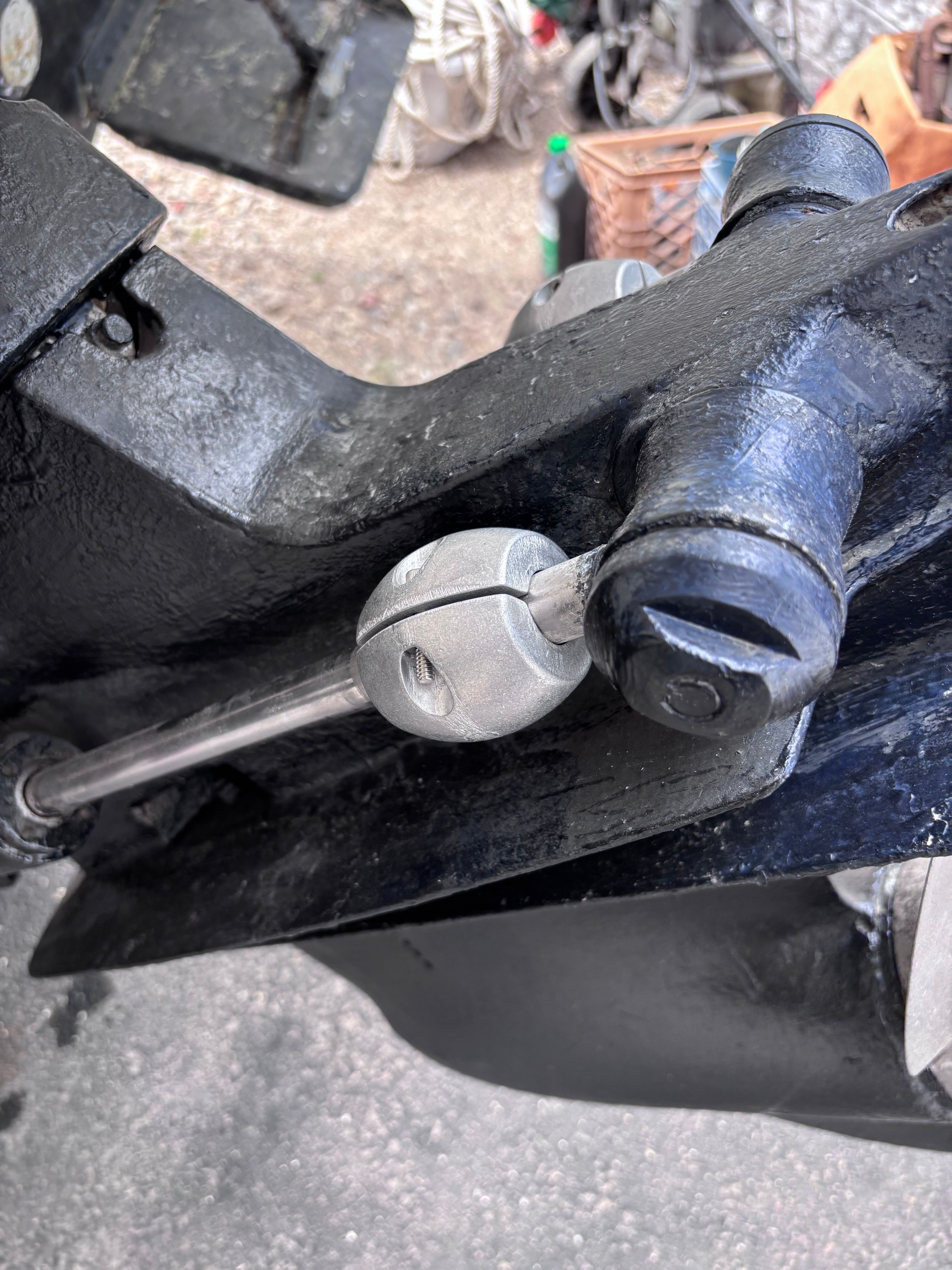 Close-up of a boat's steering rudder with metal components and bolts.