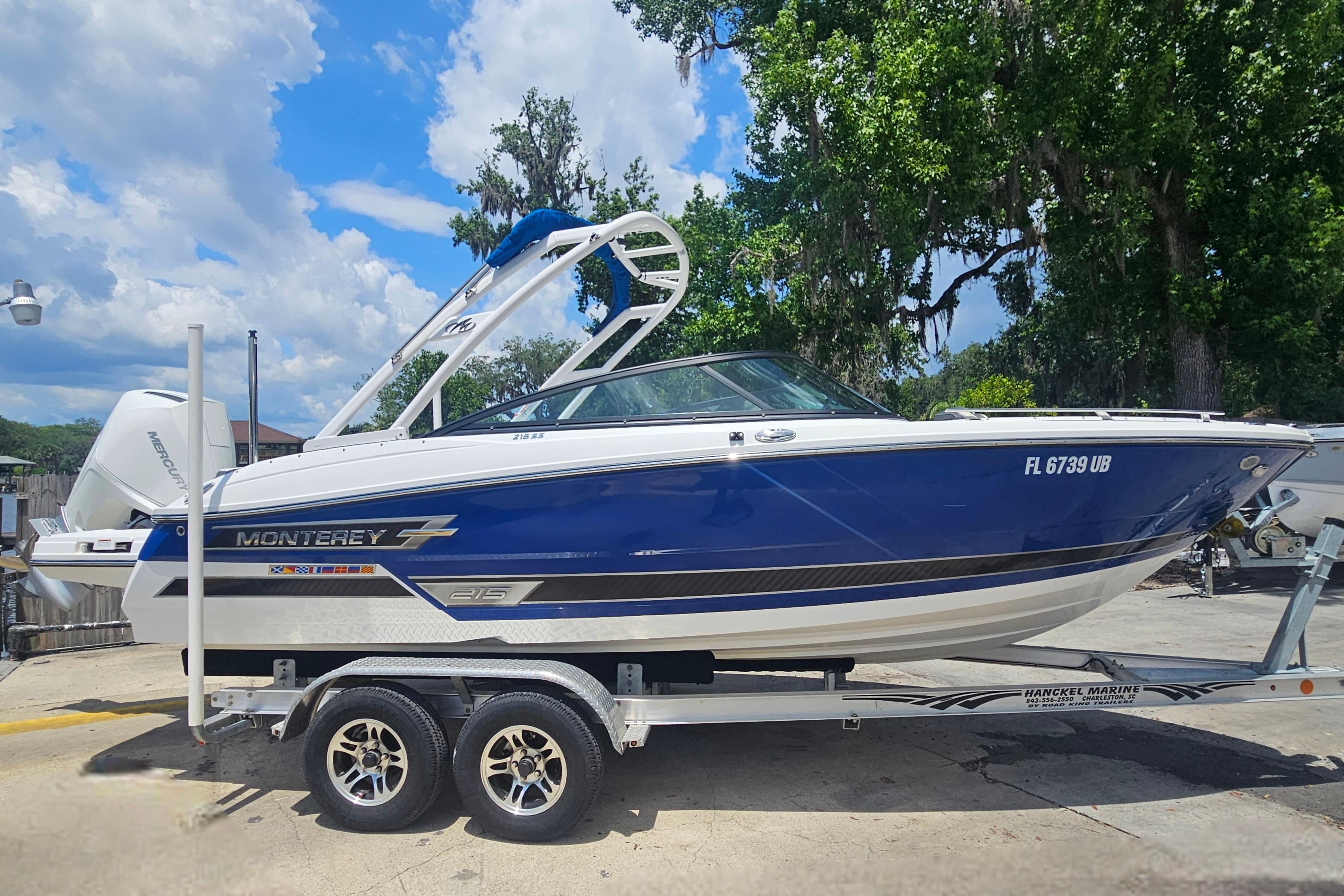 2024 Monterey 215SS Super Sport boat on trailer, blue and white design, parked outdoors.