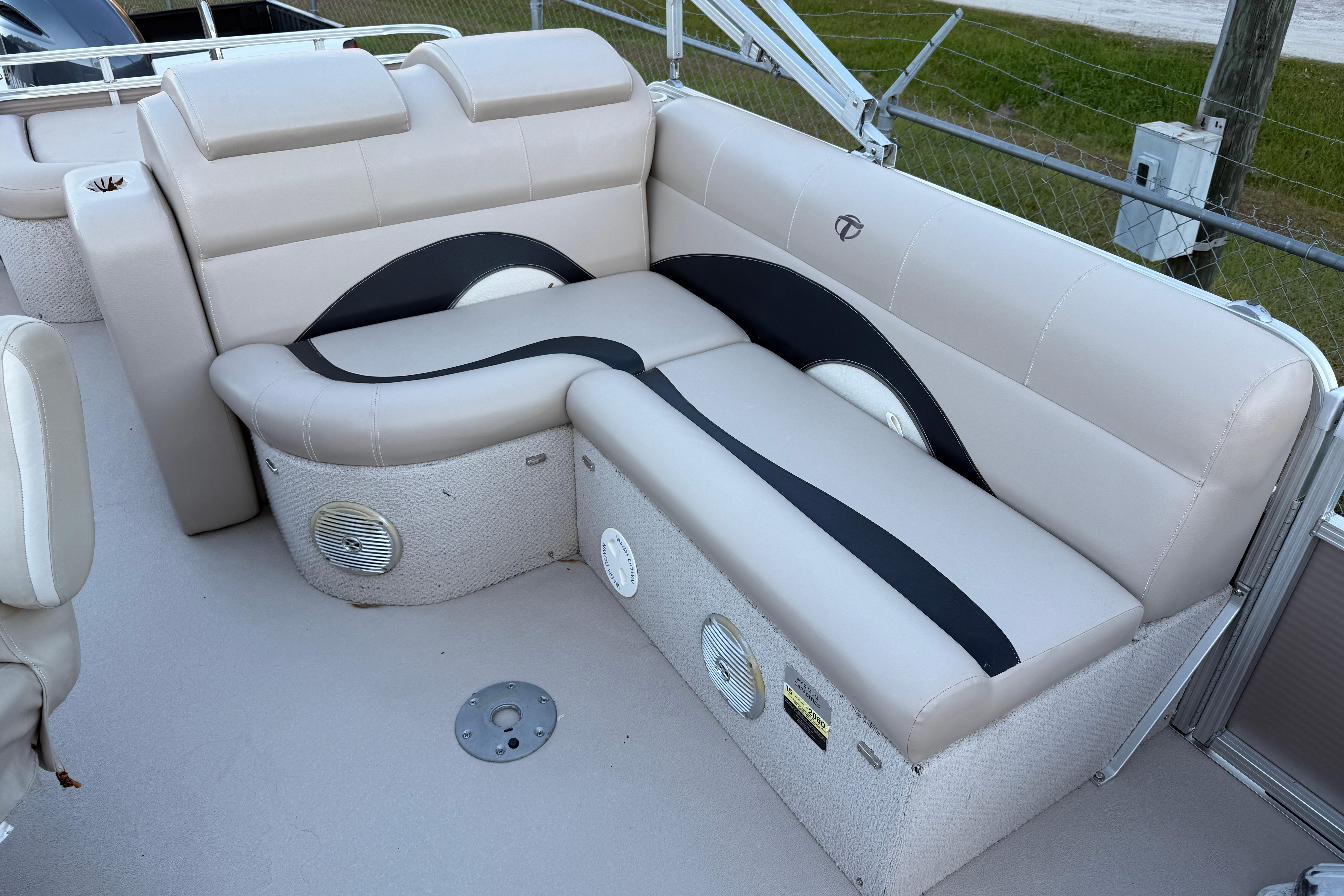 2011 Tahoe Pontoon 2485 DRL boat interior with beige seating and speaker system.