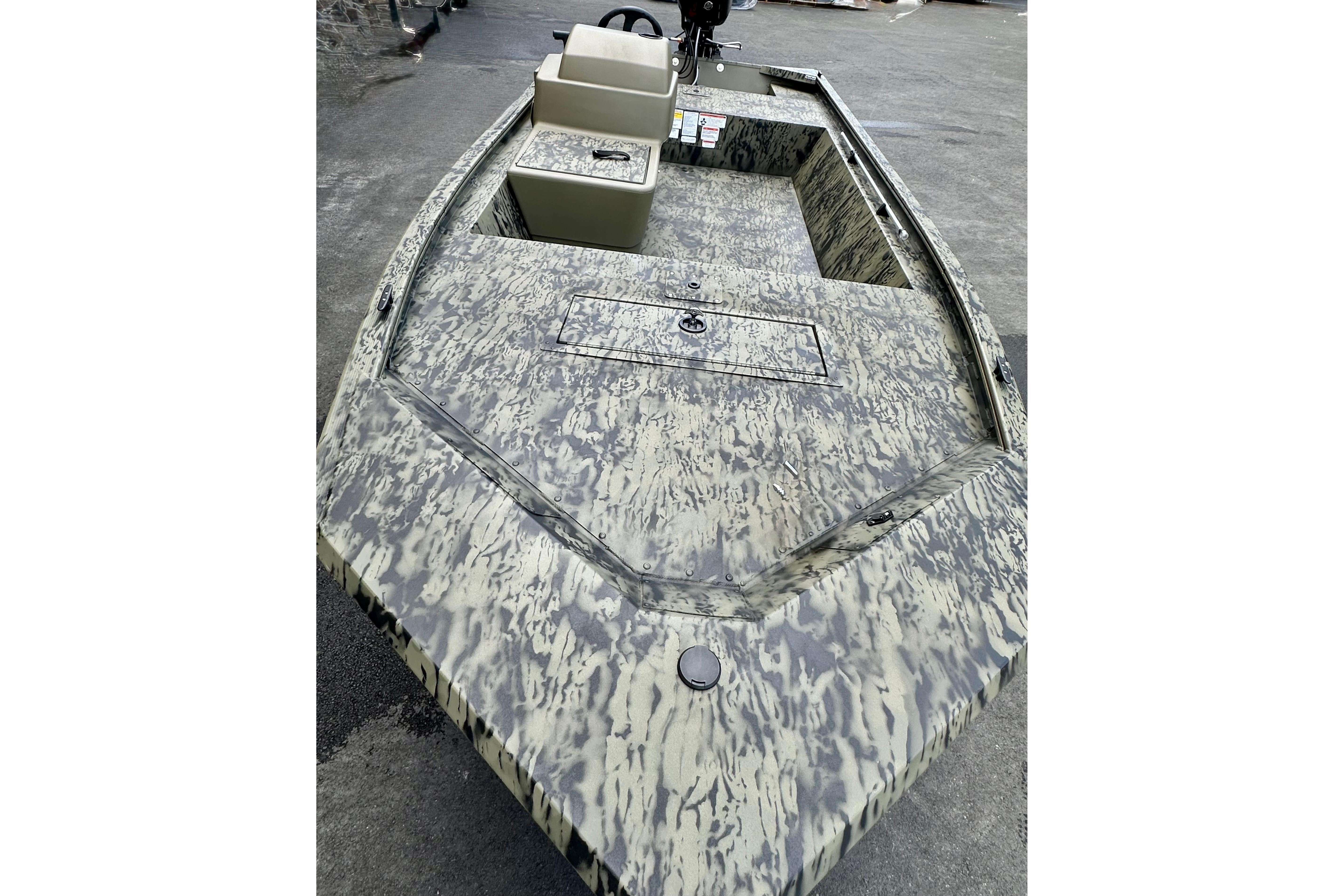 2026 Tracker Grizzly 1648 SC boat with camouflage design on a concrete surface.