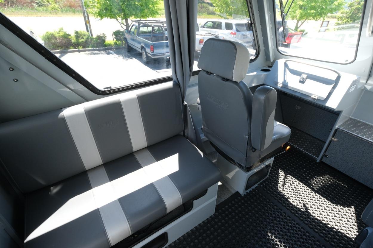 Interior of 2018 Hewescraft 220 Ocean Pro ET Hardtop, featuring gray seating and dashboard.