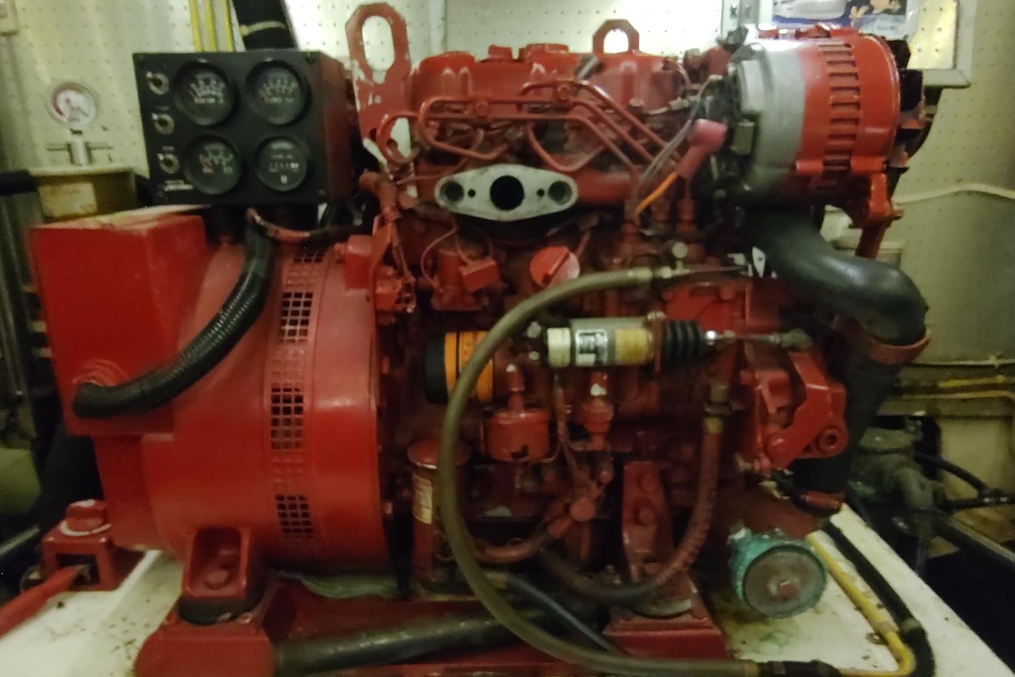 Engine room of a 1989 Hyatt Double Cabin Motoryacht, featuring a red marine engine.