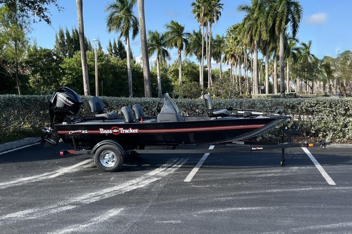 2026 Tracker Bass Tracker Classic XL boat parked under palm trees.