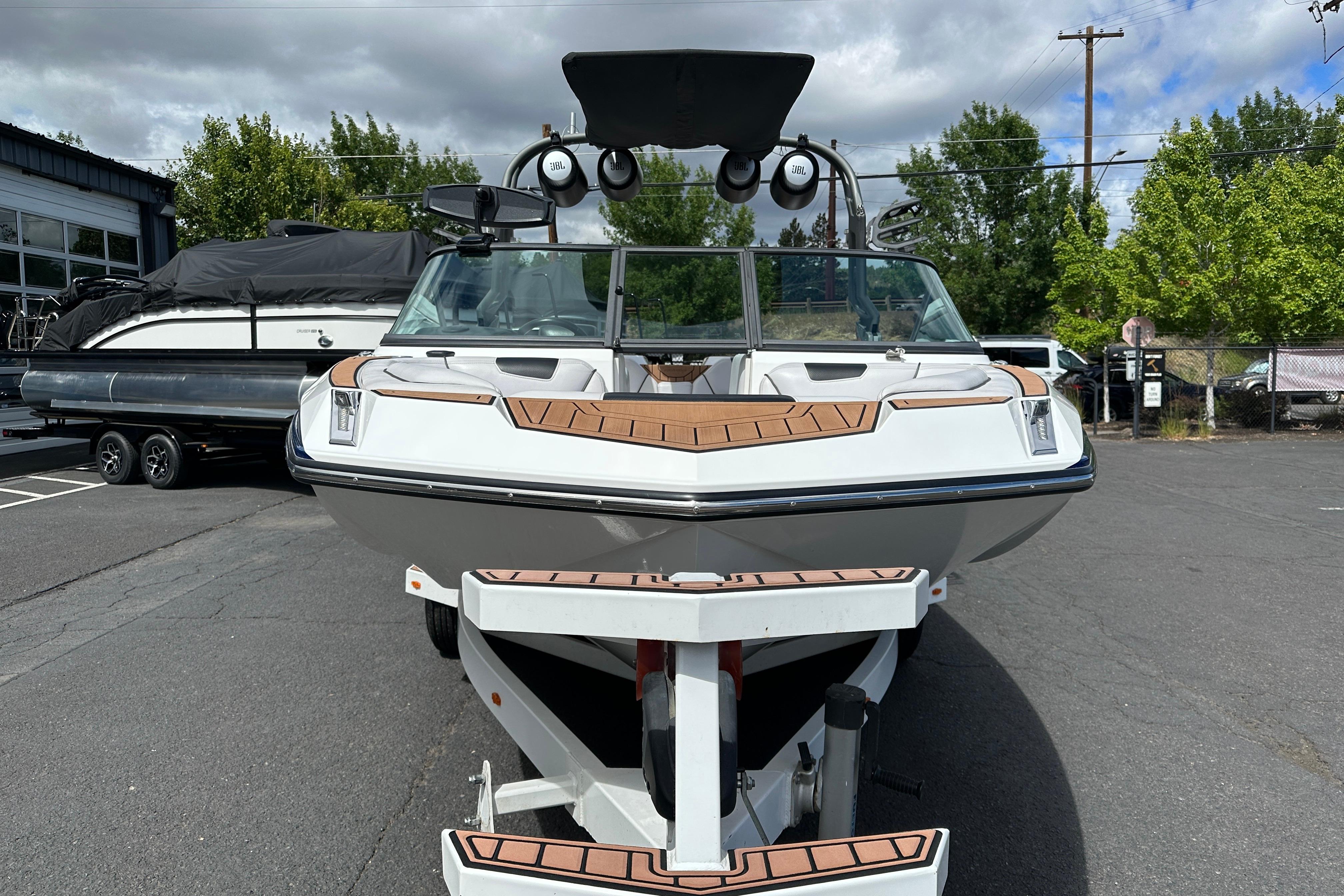 2017 Nautique Super Air Nautique GS20 boat on trailer, parked outdoors.