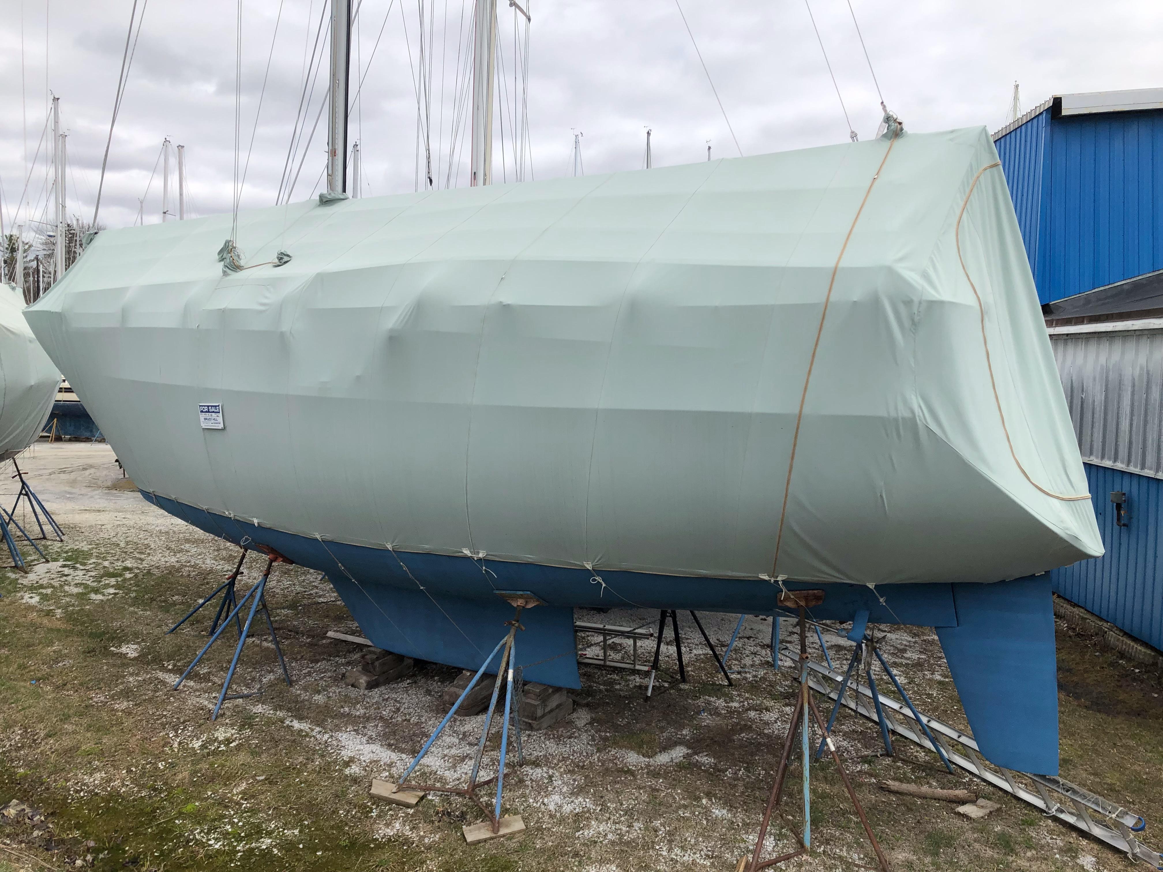 1986 Sabre 36 sailboat wrapped and supported on stands.