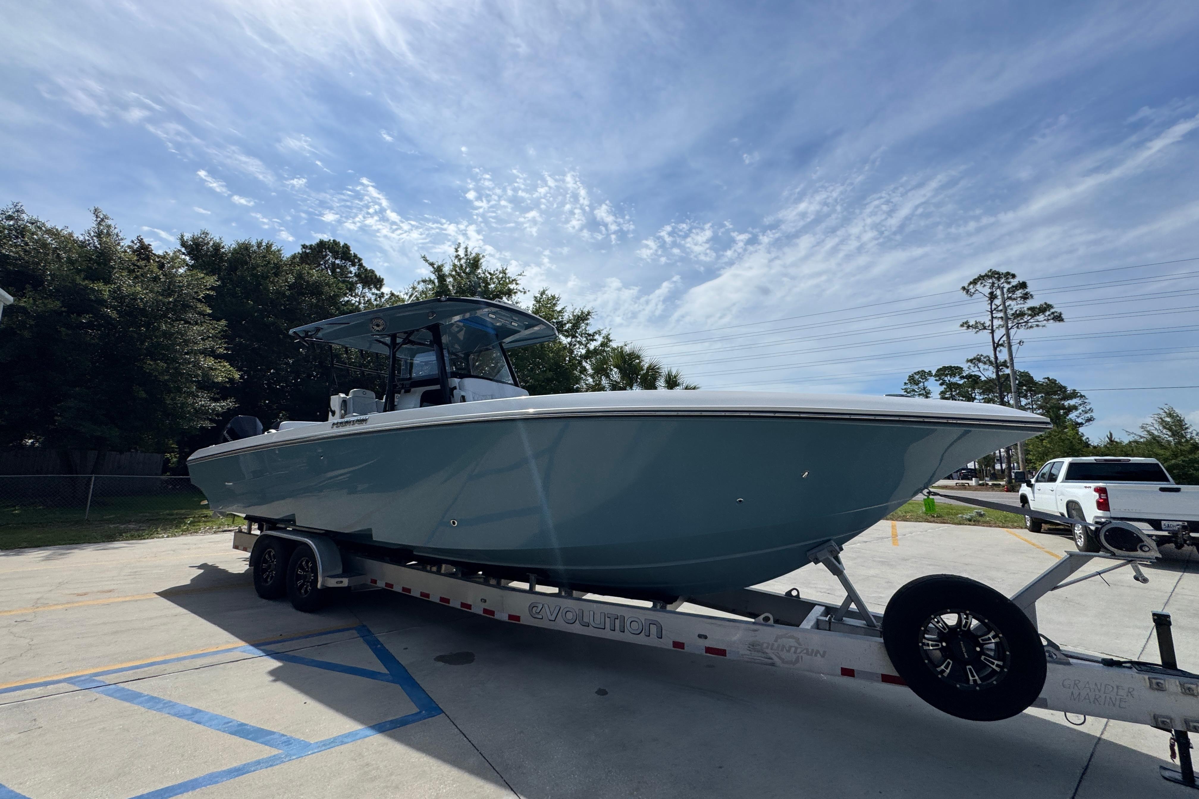 2023 Fountain 34 Tournament Edition boat on trailer under a clear sky.