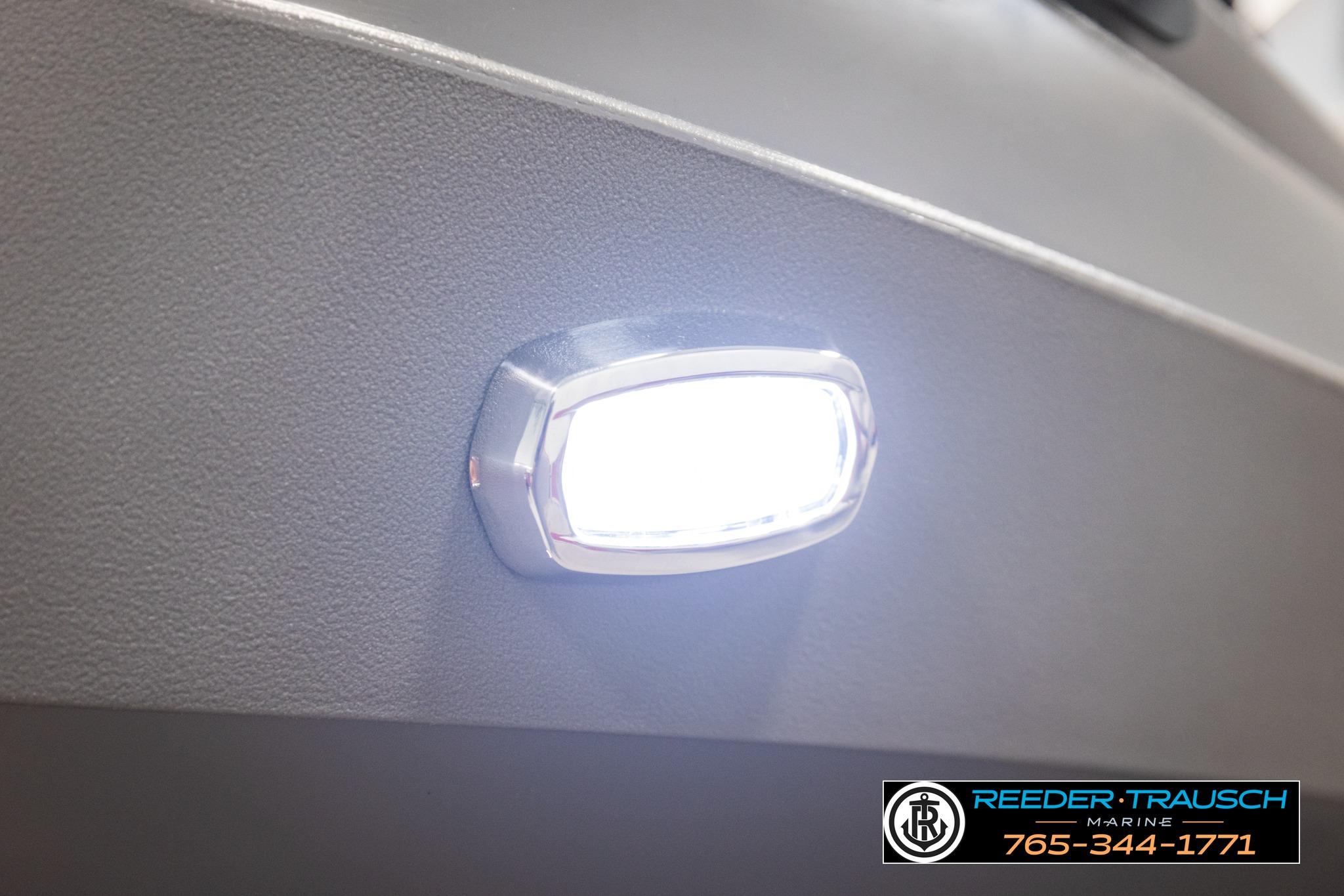 Close-up of a 2026 Avalon LSZ QL boat light, illuminated against a textured surface.