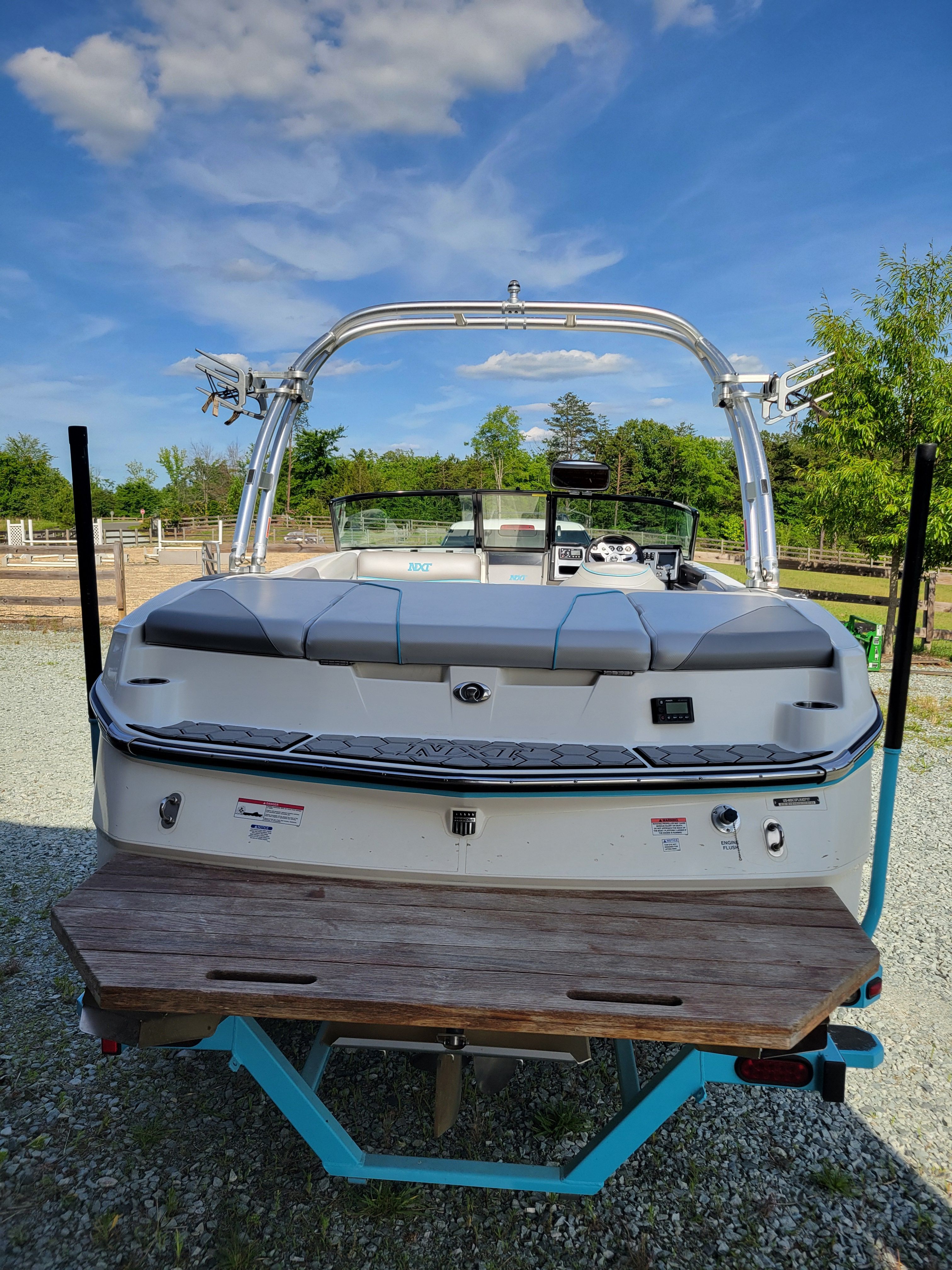 2017 MasterCraft NXT20 boat, rear view on gravel lot.
