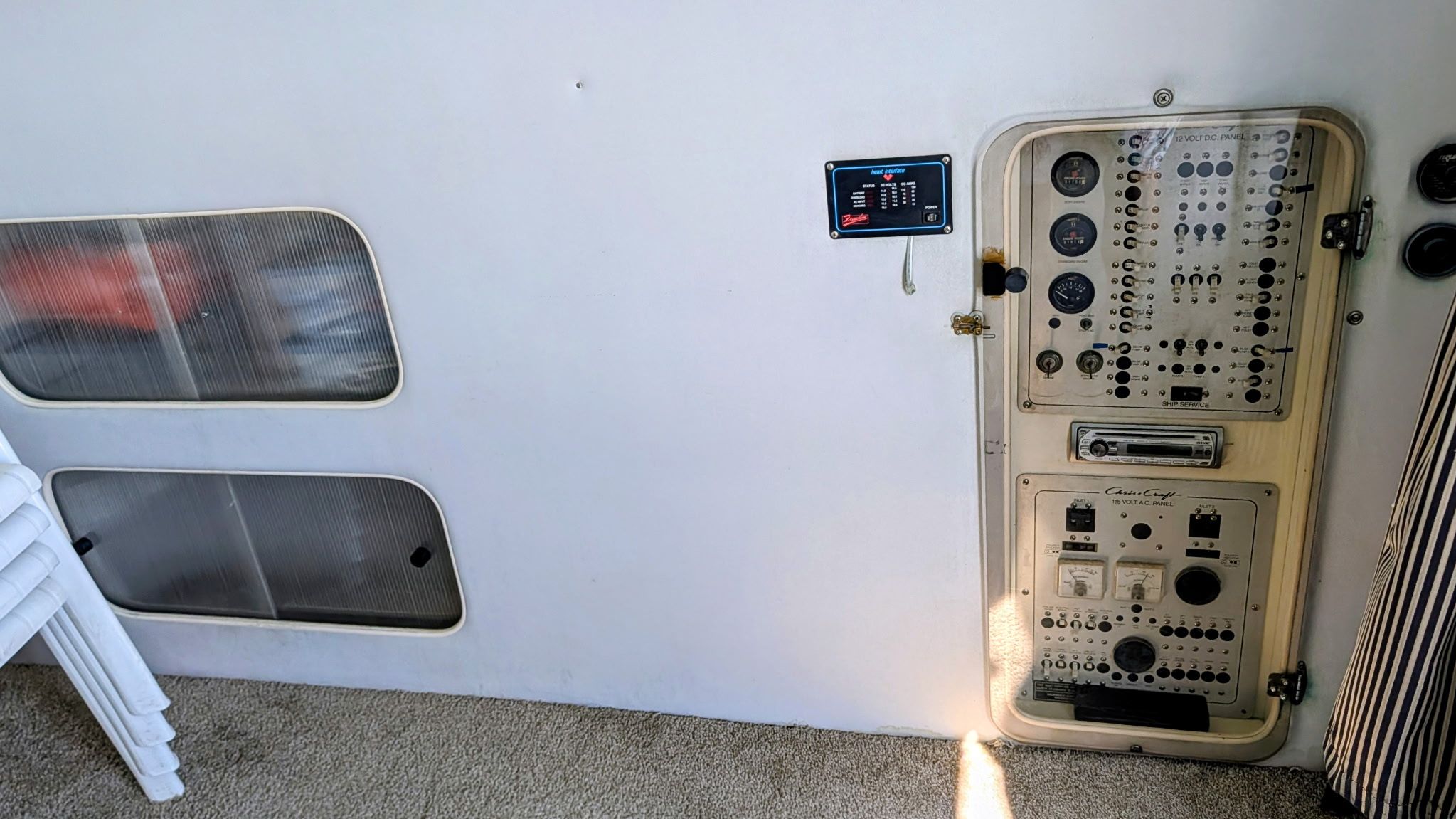 Interior view of a 1987 Chris-Craft 320 Amerosport Express with a control panel and windows.