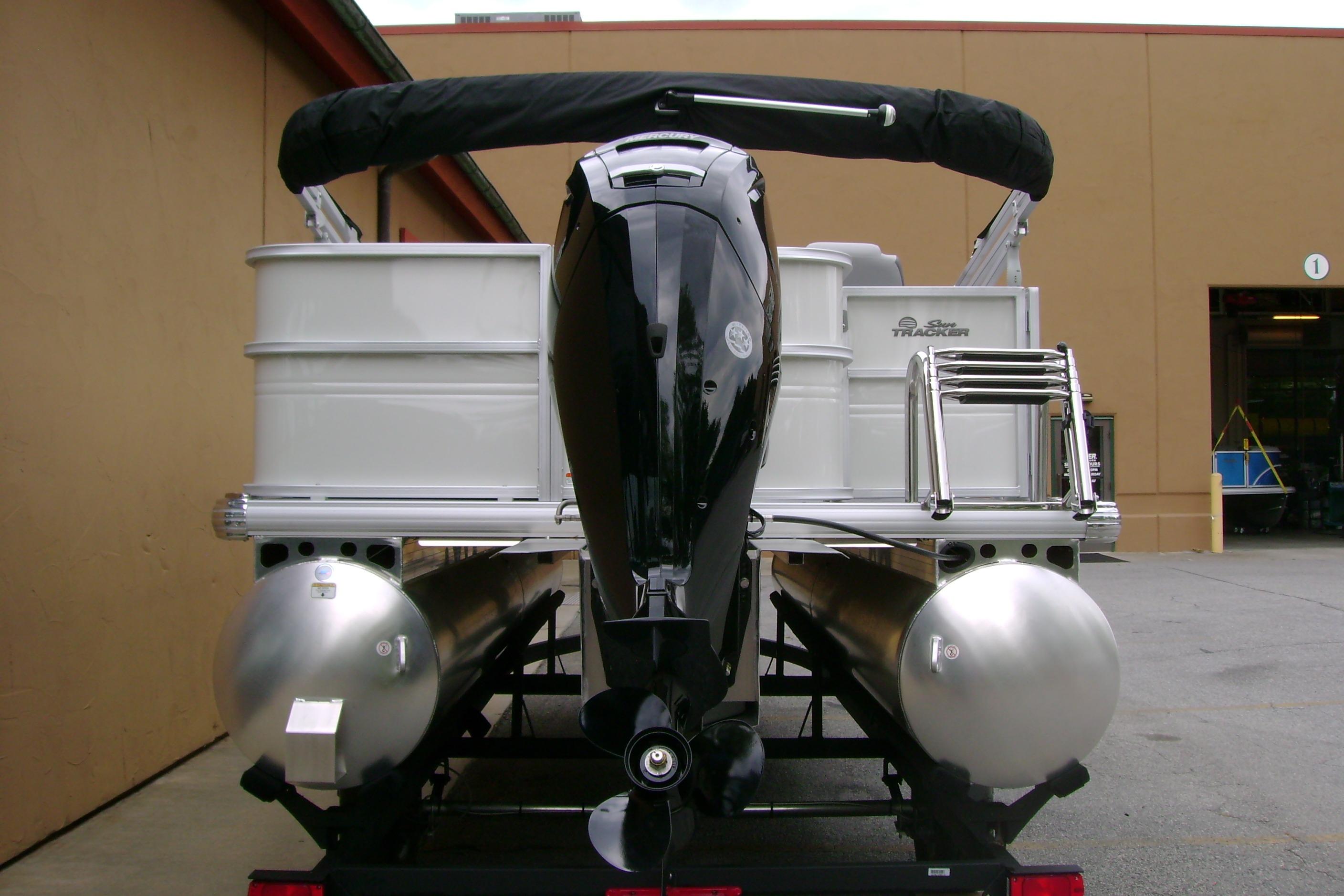2026 Sun Tracker Party Barge 18 DLX pontoon boat rear view with motor and ladder.