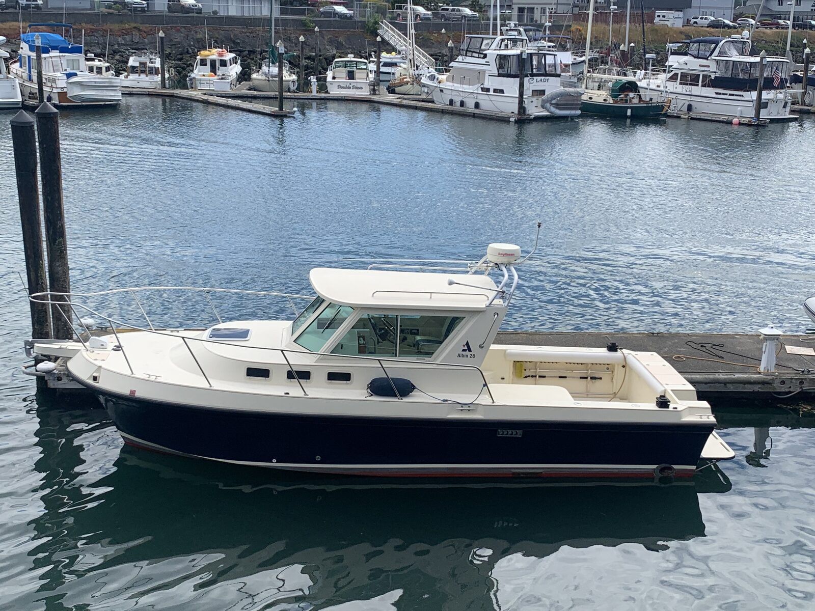 A 2001 Albin Tournament Express boat is docked in the harbor.