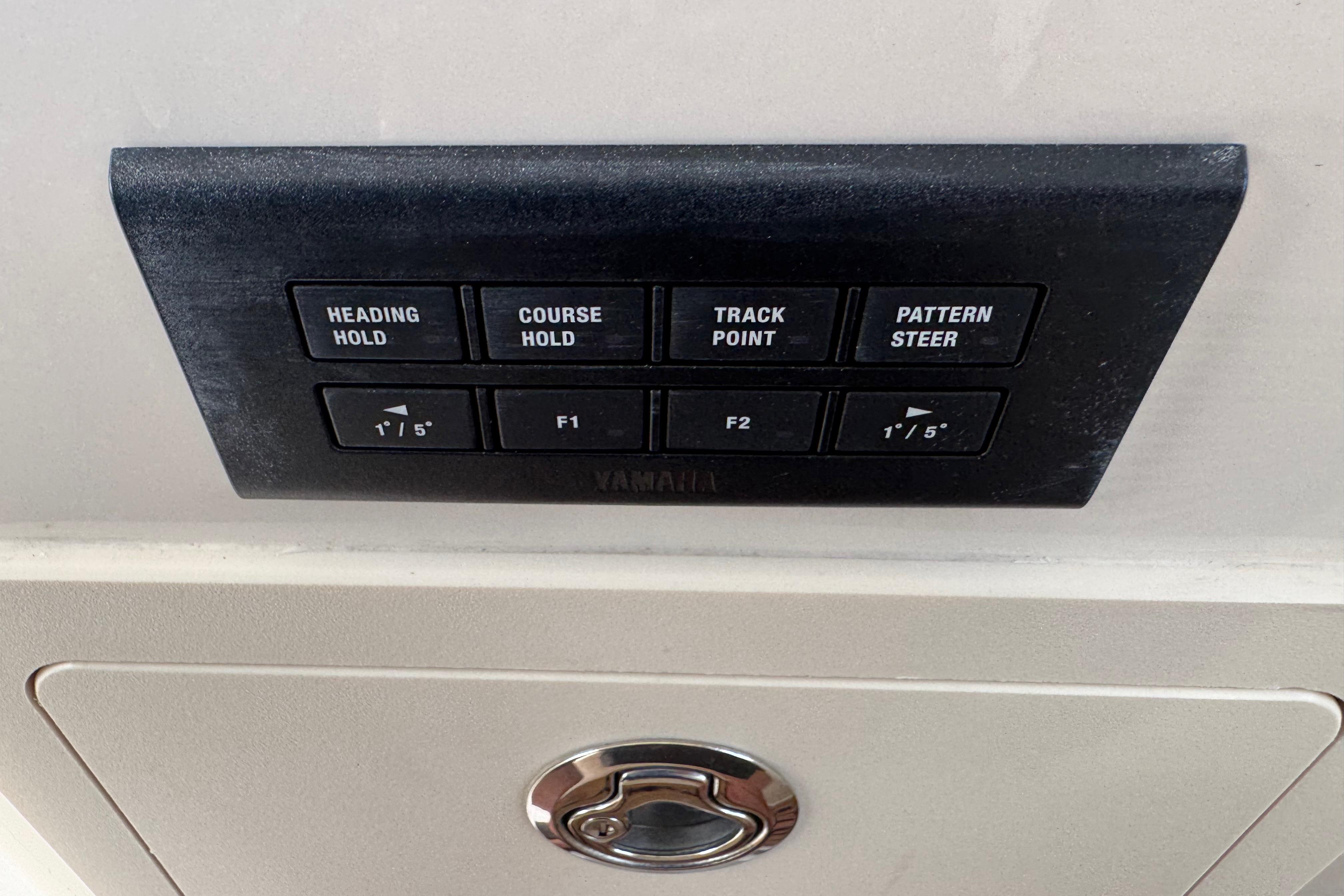 Control panel on 2024 Grady-White Freedom 335 boat with navigation buttons.