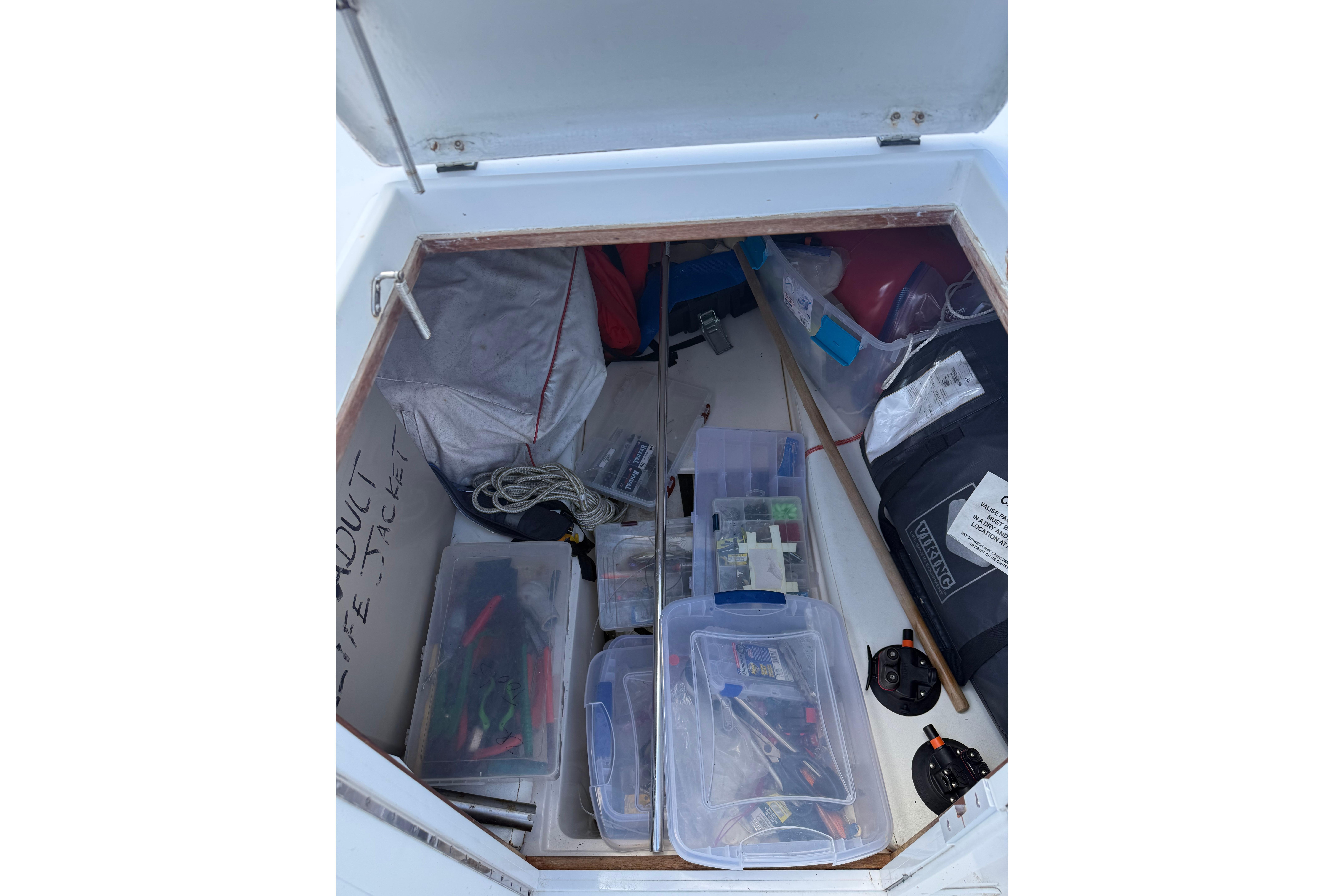 Storage compartment of 1992 Intrepid 289 Center Console with organized gear and equipment.