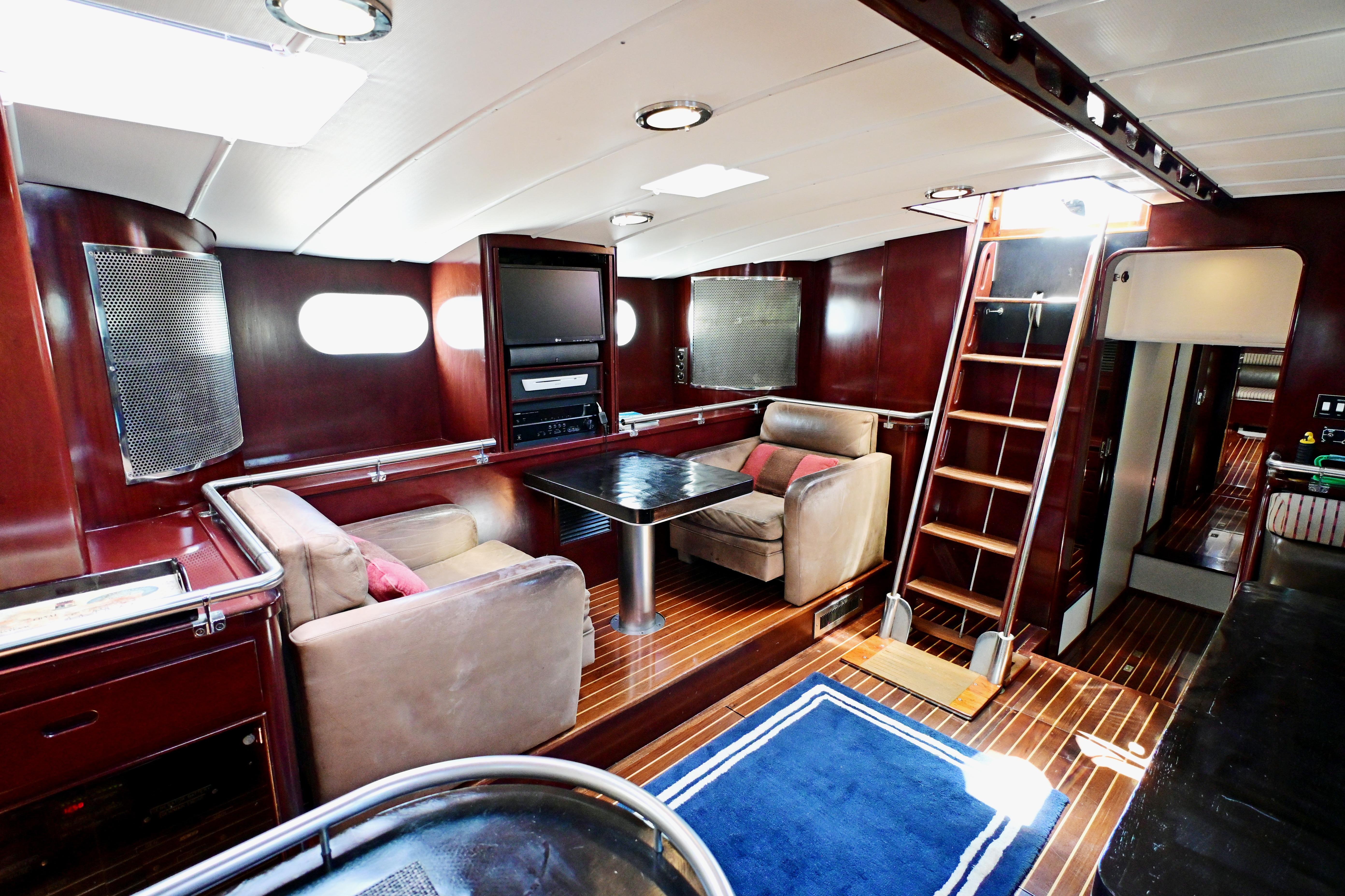 Luxurious 1968 Abeking & Rasmussen Tripp 74 yacht interior with elegant wood finishes and cozy seating.