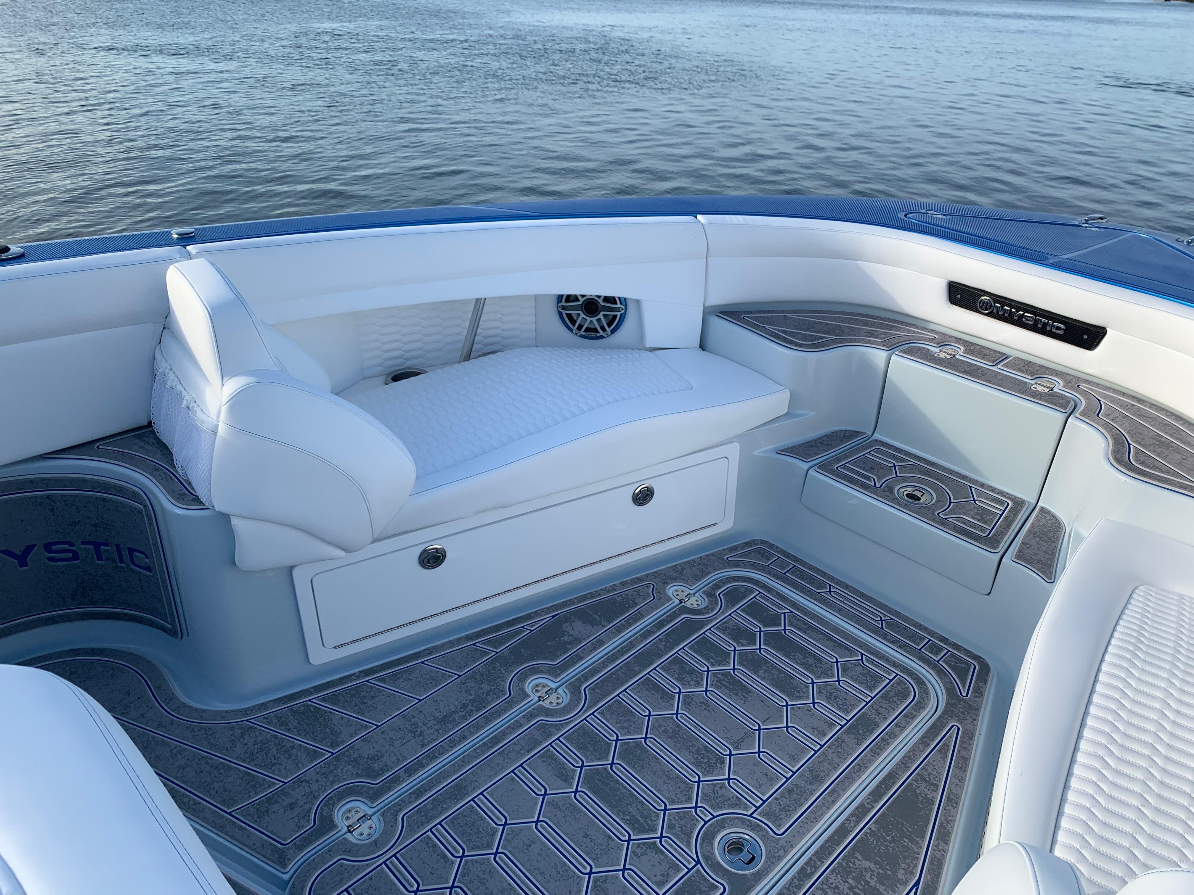 2023 Mystic Powerboats M3800 interior with white seating and elegant flooring.