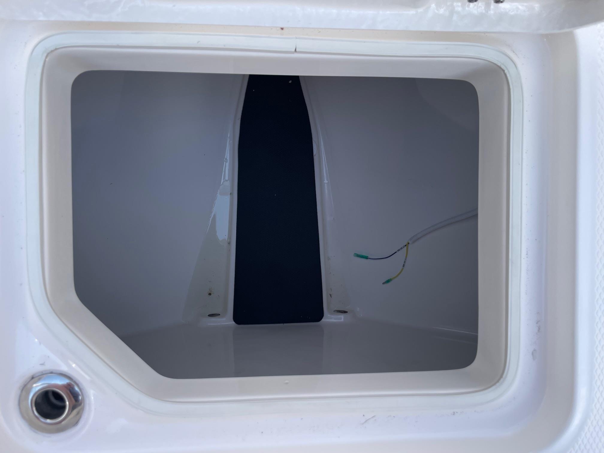 2025 Robalo R230 Center Console storage compartment interior view.