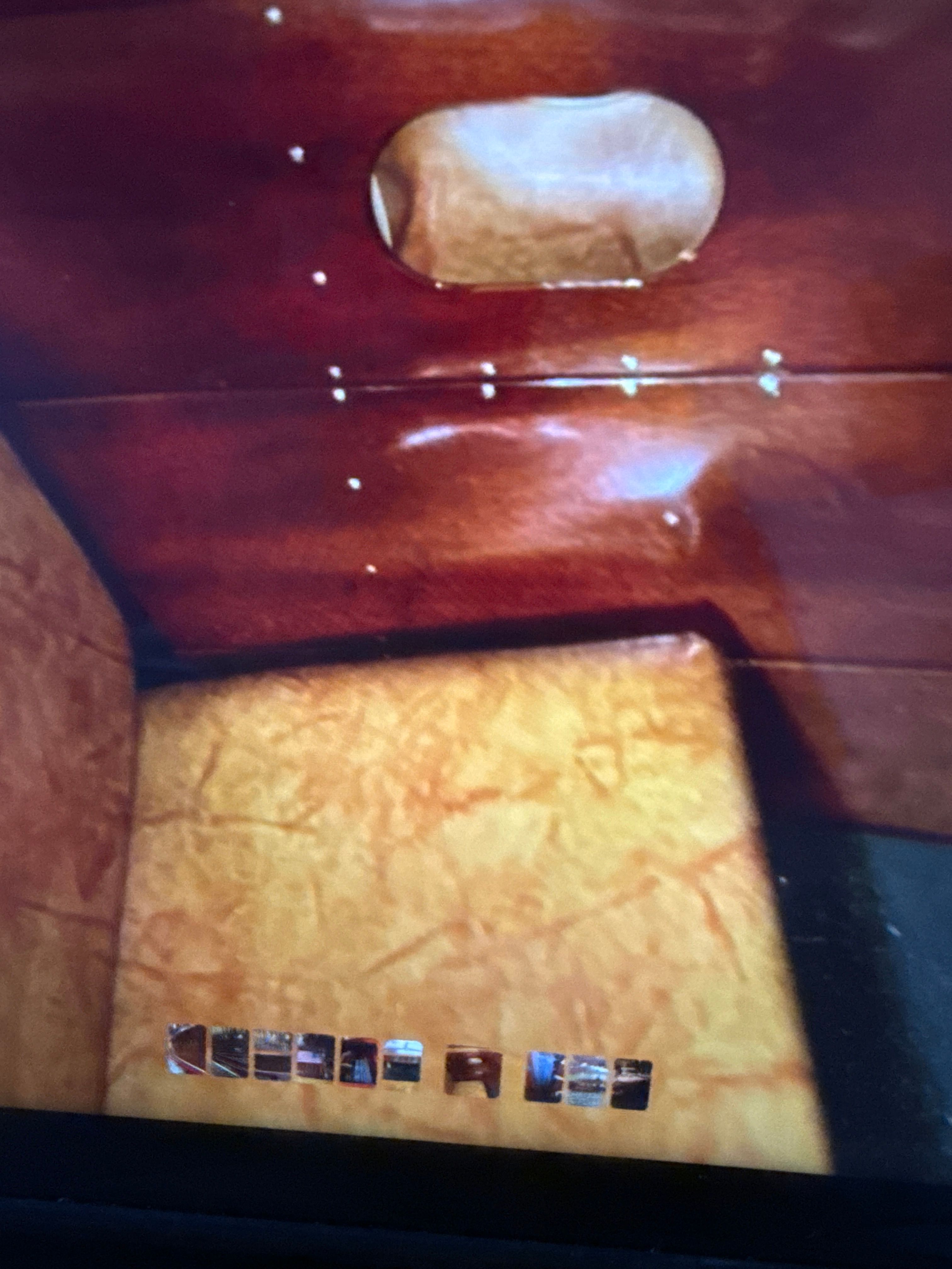 Interior of 1940 Chris-Craft Barrelback boat, featuring wood paneling and upholstery.